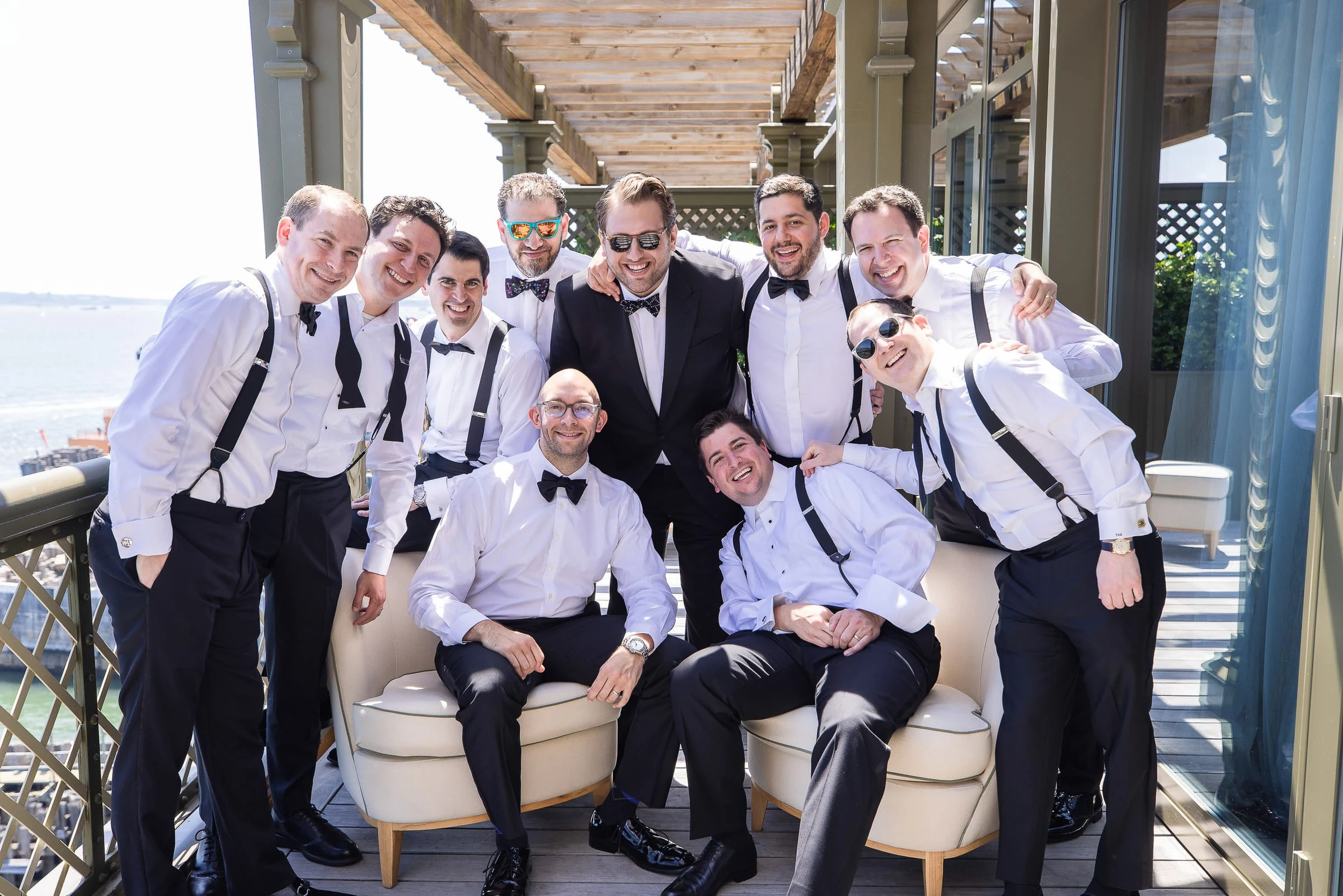 The groomsmen in braces and bow ties on the terrace — Casa Cipriani, New York