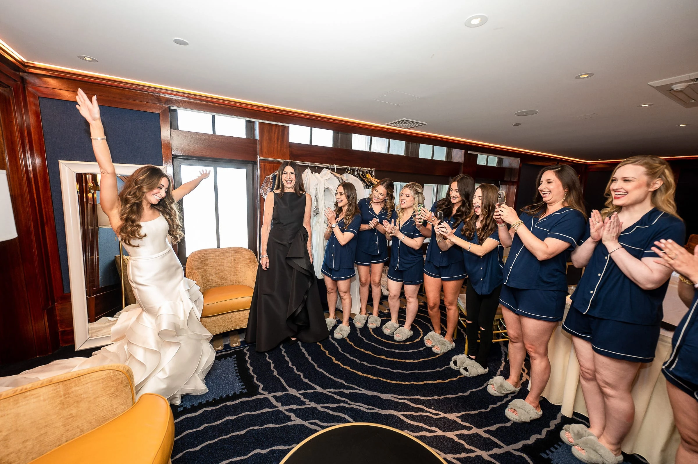 The bride showing her gown to the bridesmaids in matching pyjamas — Casa Cipriani, New York
