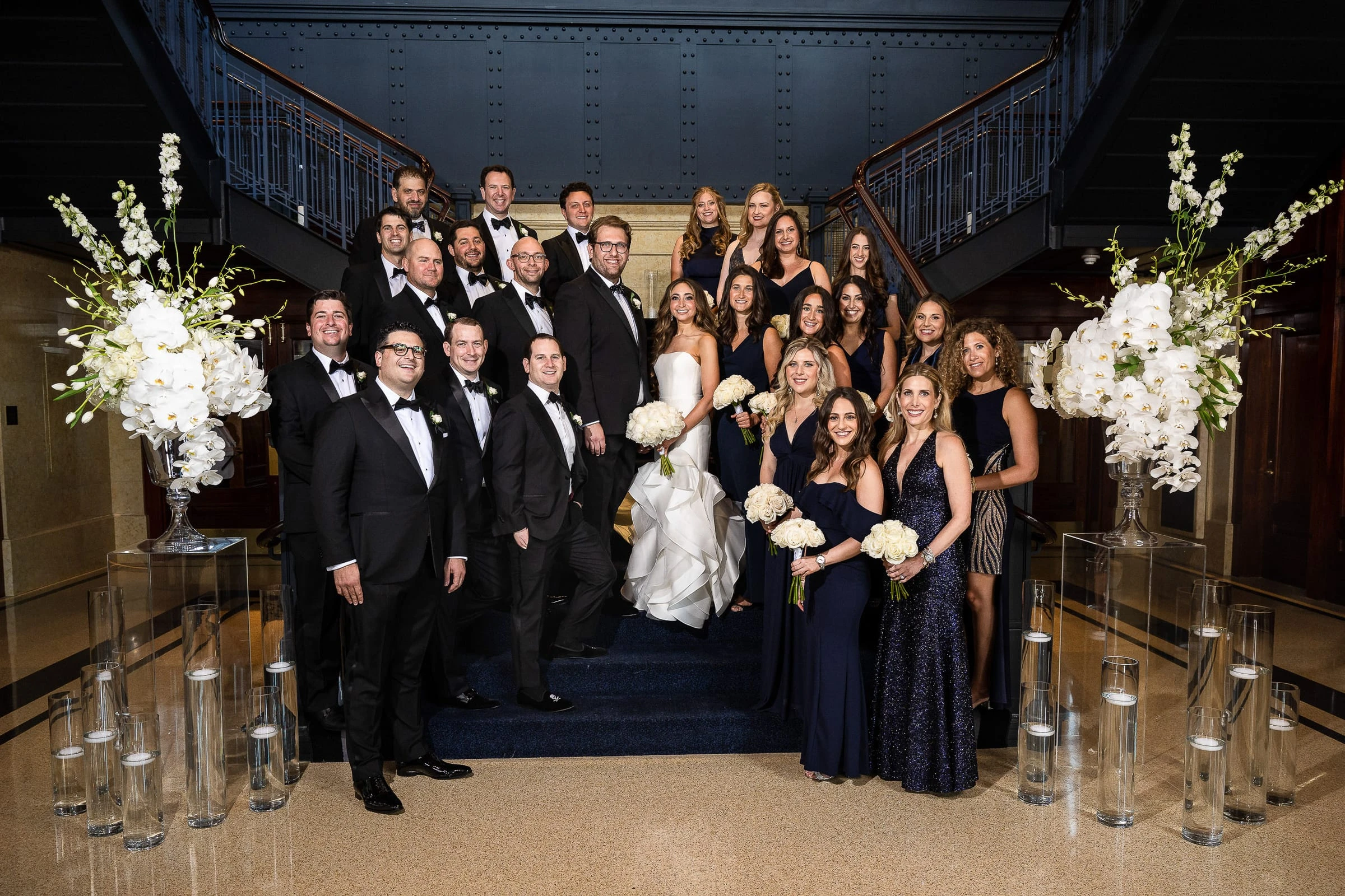 The wedding party gathered on the staircase — Casa Cipriani, New York