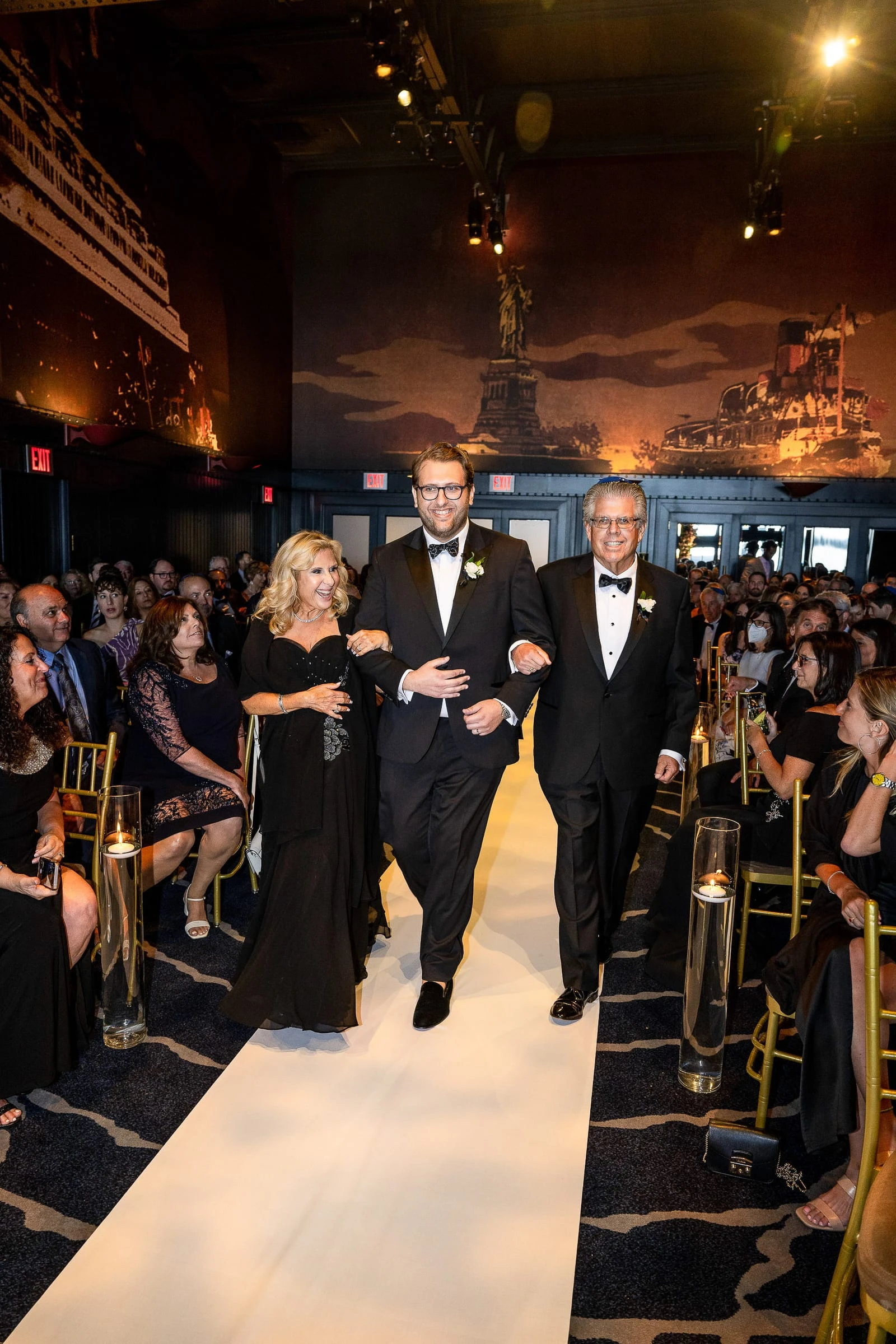 The groom walking the aisle between his parents — Casa Cipriani, New York