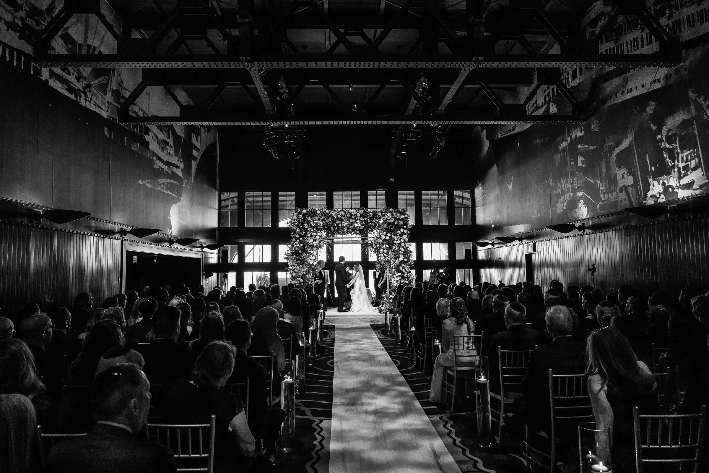 The ceremony in the mural-lined hall, in black and white — Casa Cipriani, New York