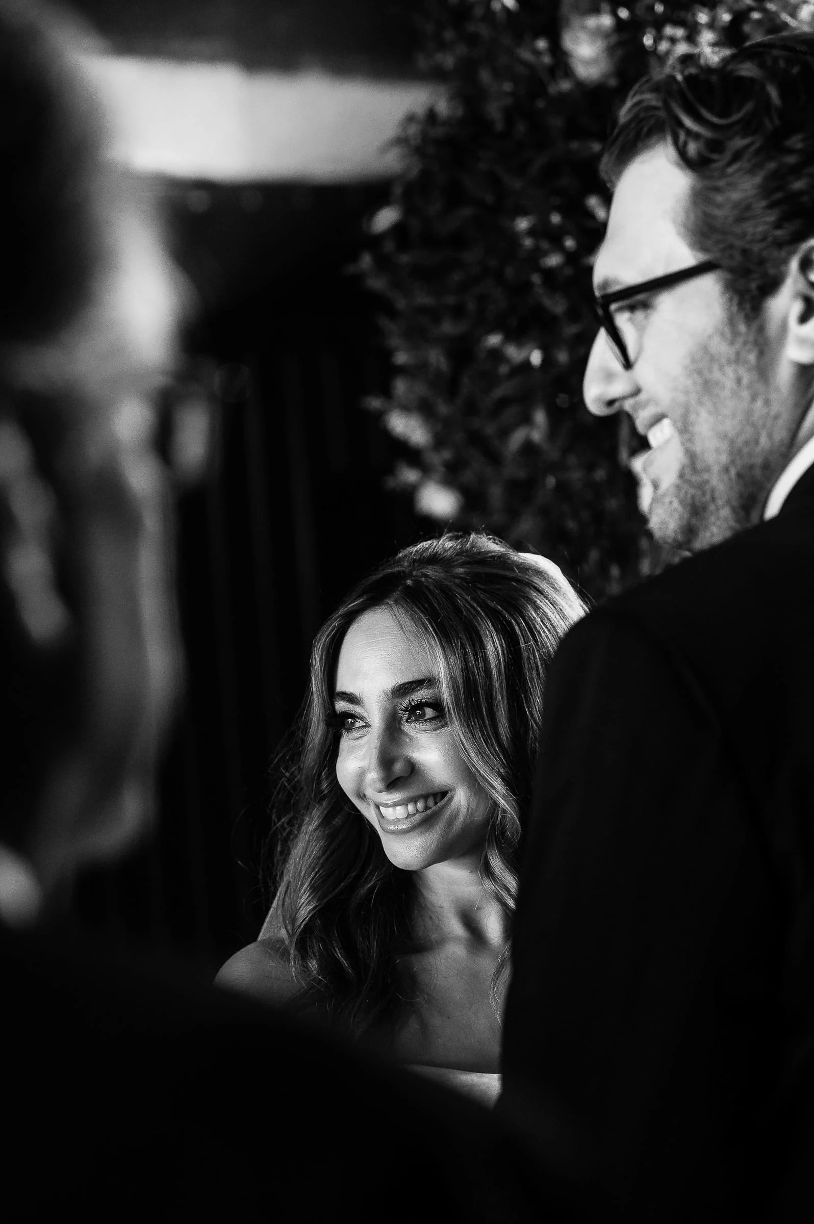 The bride smiling beside the groom during the ceremony, in black and white — Casa Cipriani, New York