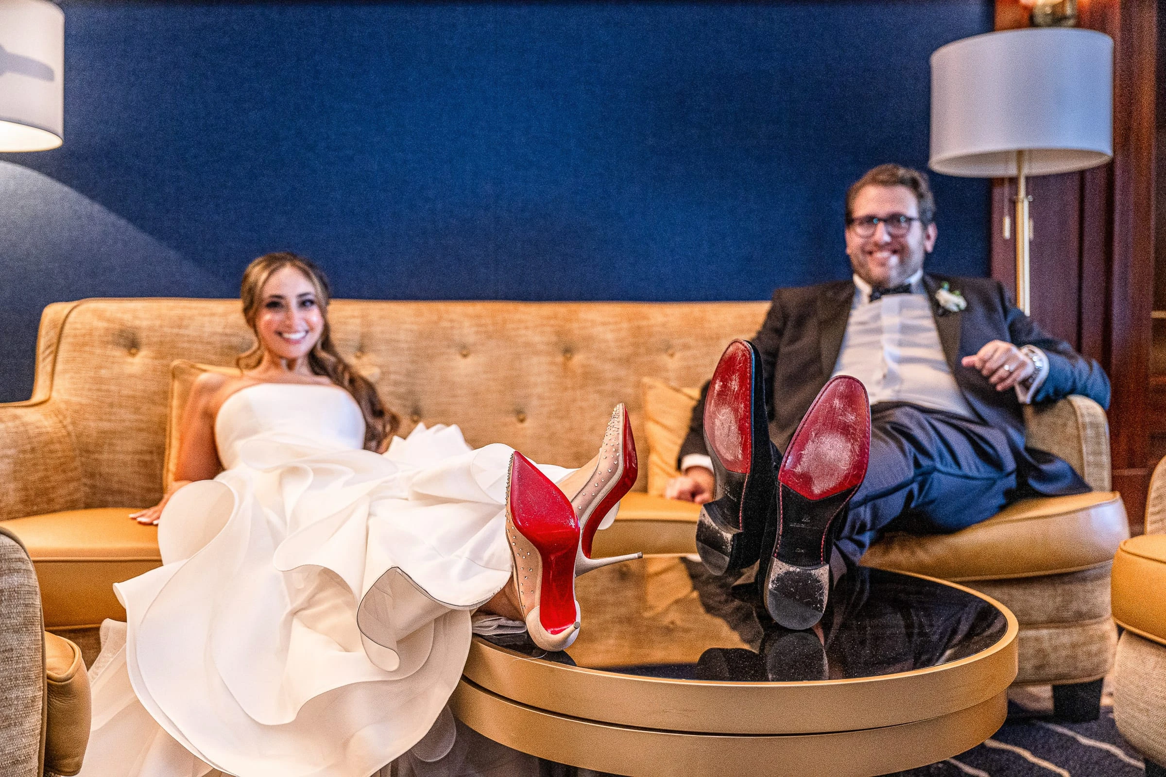 The couple on the sofa with their red-soled shoes up on the table — Casa Cipriani, New York