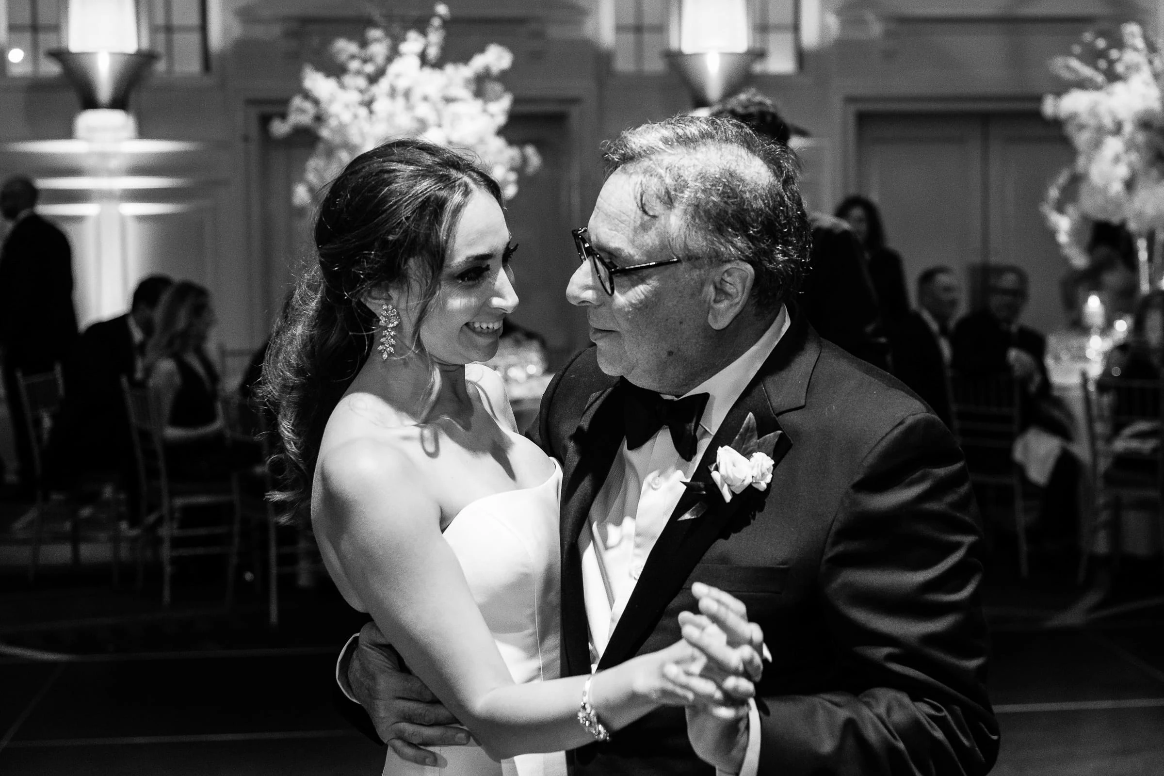 The bride dancing with an older man in glasses, in black and white — Casa Cipriani, New York