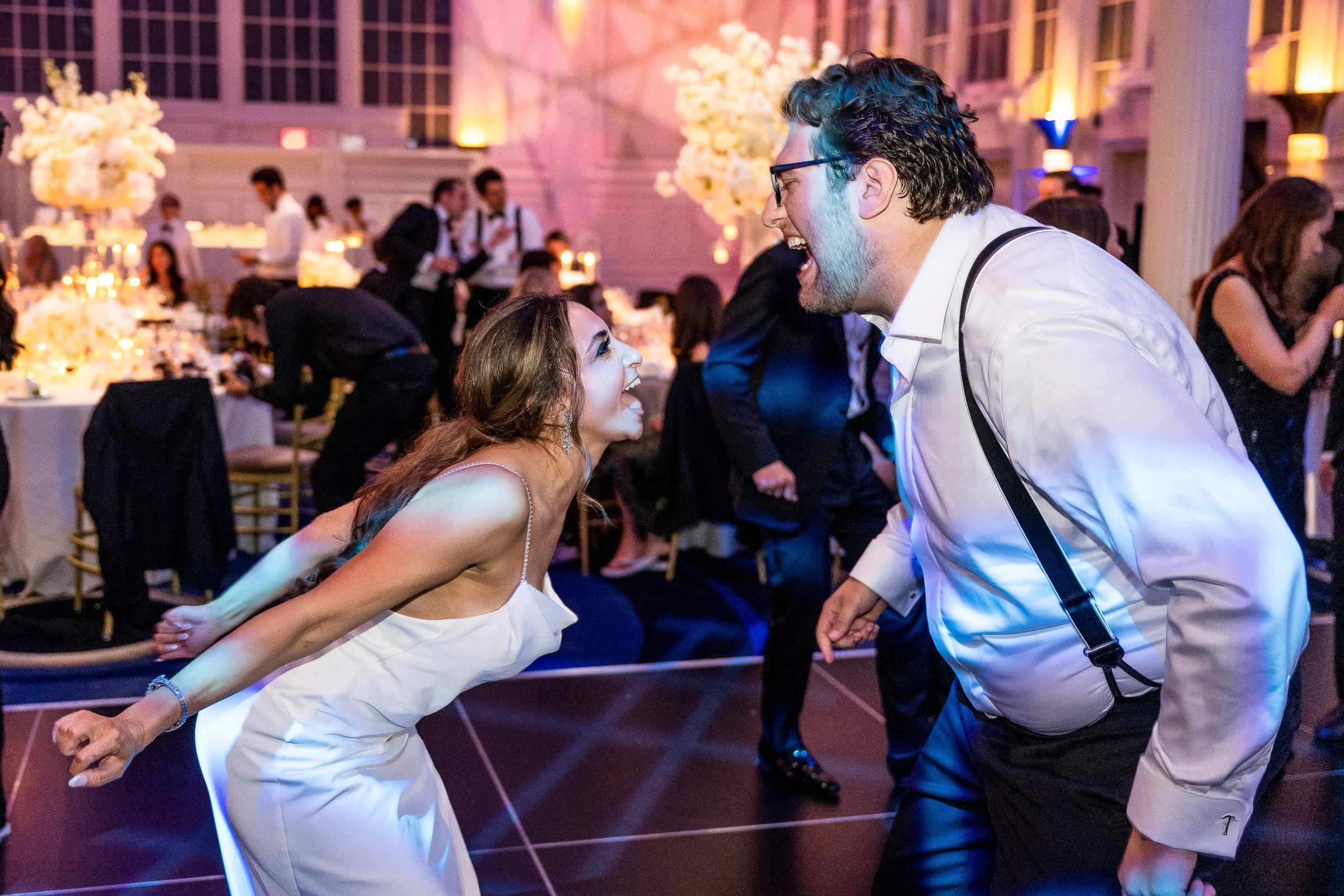 The bride and groom leaning in and laughing at each other on the dance floor — Casa Cipriani, New York