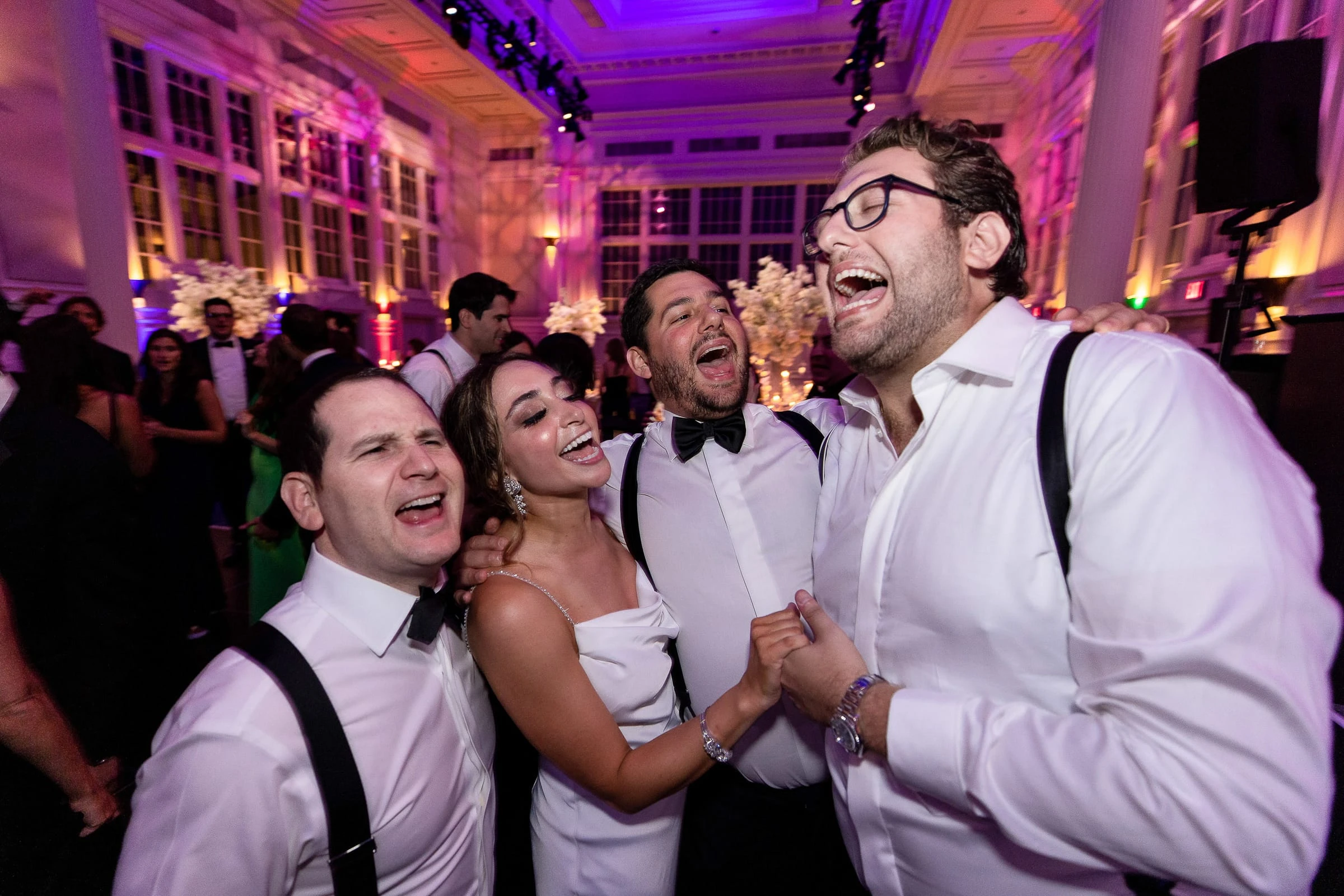 The bride singing along arm in arm with the groom and his friends — Casa Cipriani, New York