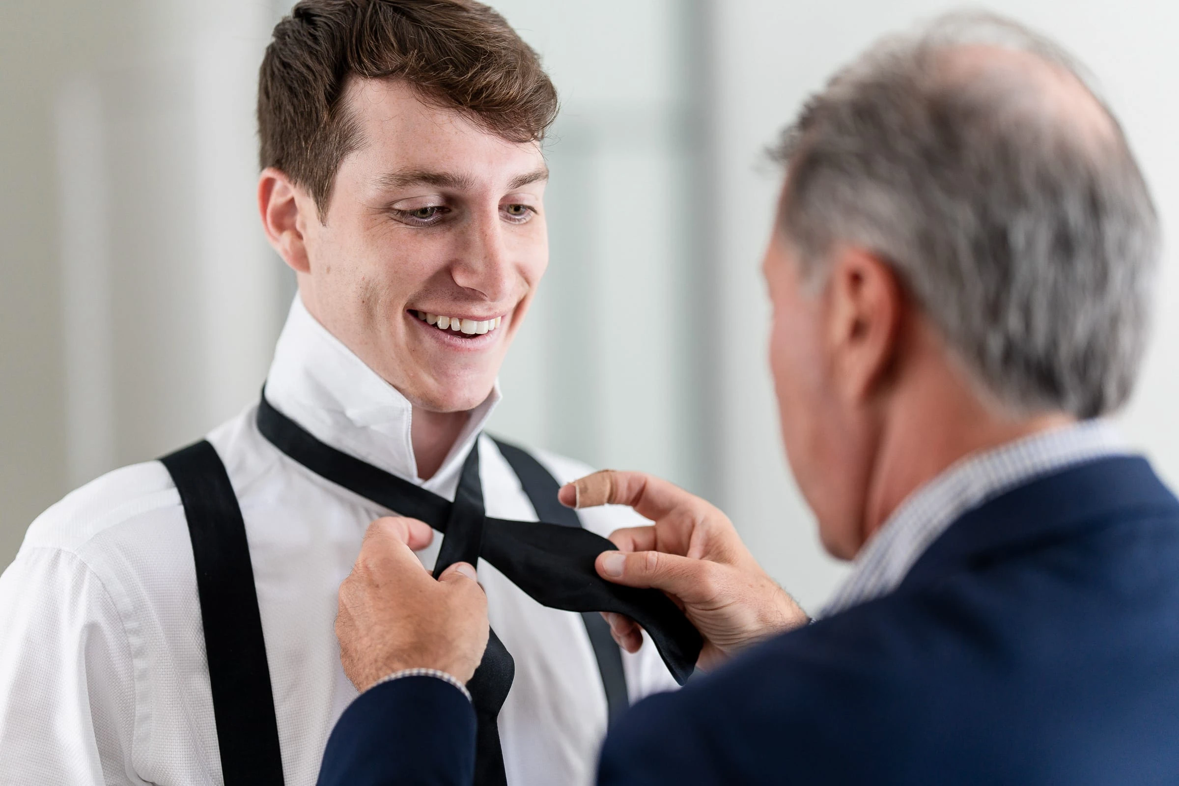 The groom having his tie tied before the ceremony — Shadowbrook at Shrewsbury, Shrewsbury