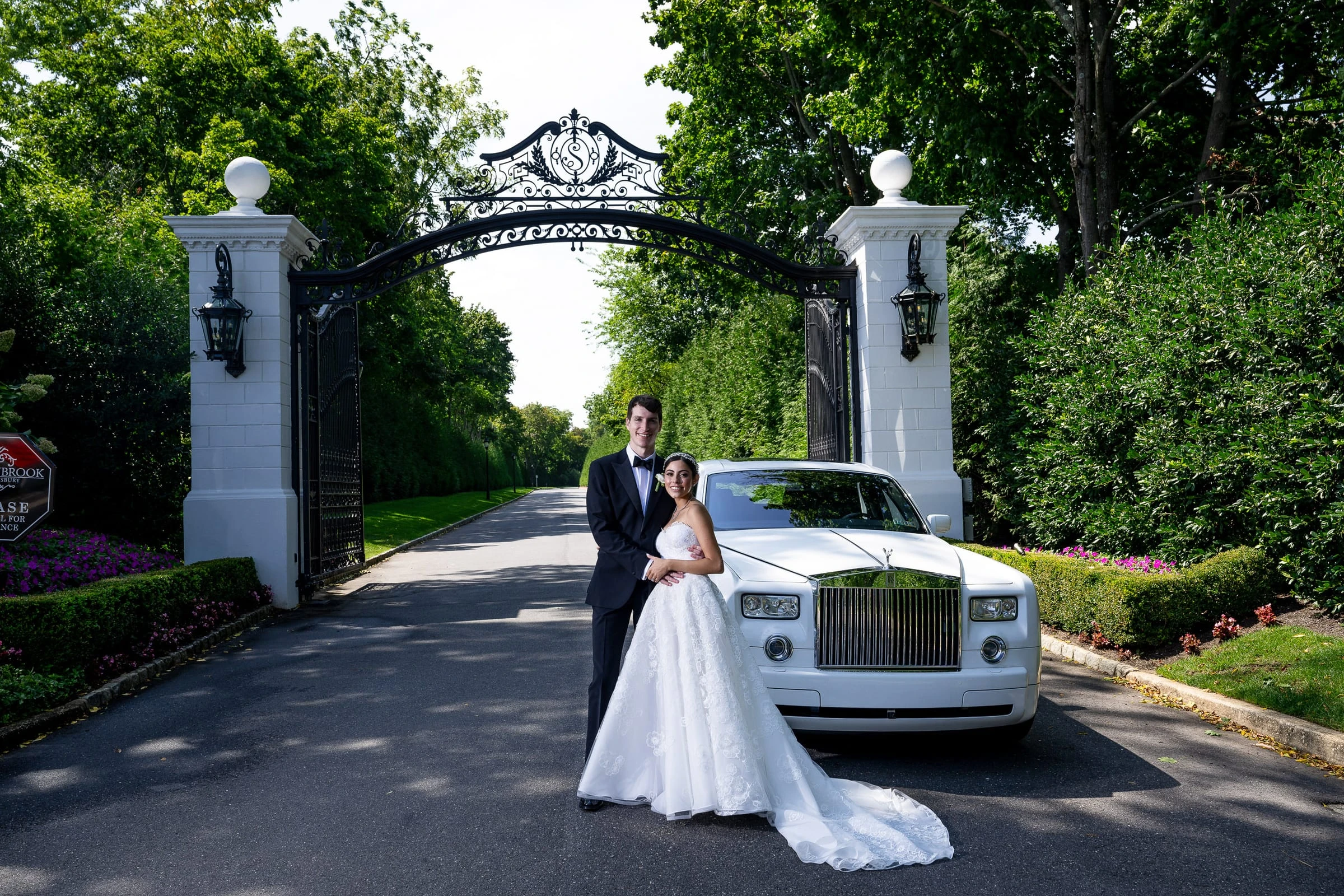 The couple beside a white Rolls-Royce at the gates — Shadowbrook at Shrewsbury, Shrewsbury