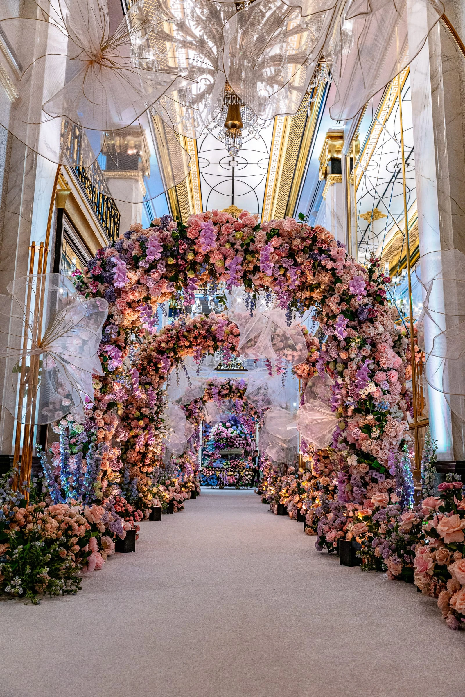 A tunnel of pink and coral flowers arching over the ceremony aisle — Shadowbrook at Shrewsbury, Shrewsbury