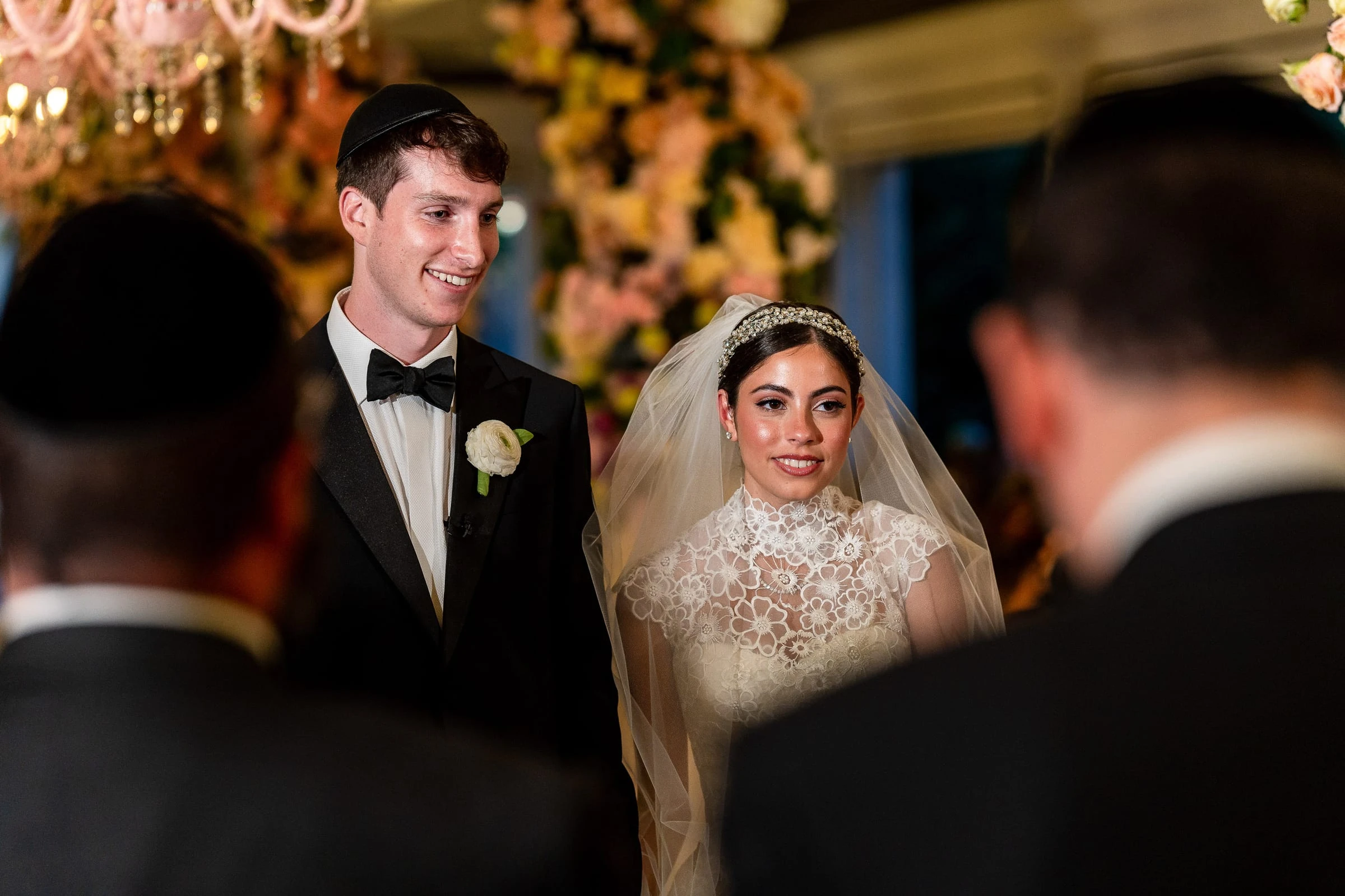 The couple during the ceremony seen between the guests — Shadowbrook at Shrewsbury, Shrewsbury