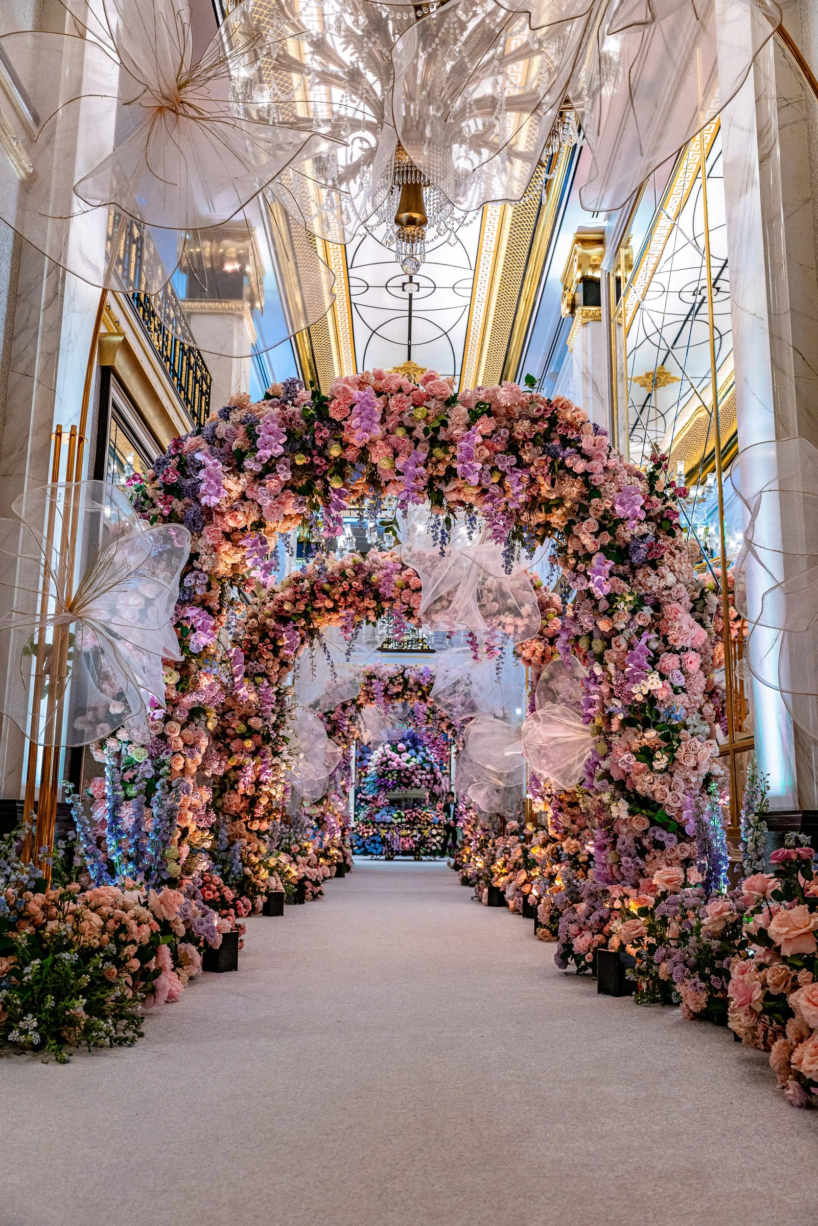 A tunnel of pink and coral flowers arching over the ceremony aisle — Shadowbrook at Shrewsbury, Shrewsbury