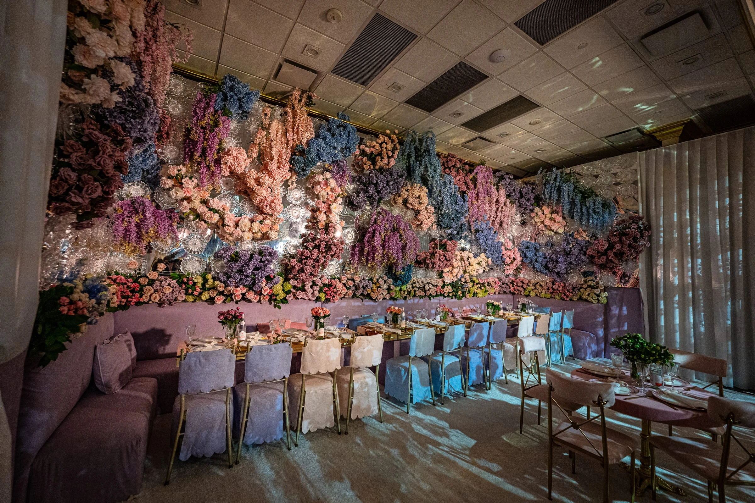 The reception room with a wall of cascading pastel flowers above the long table — Shadowbrook at Shrewsbury, Shrewsbury