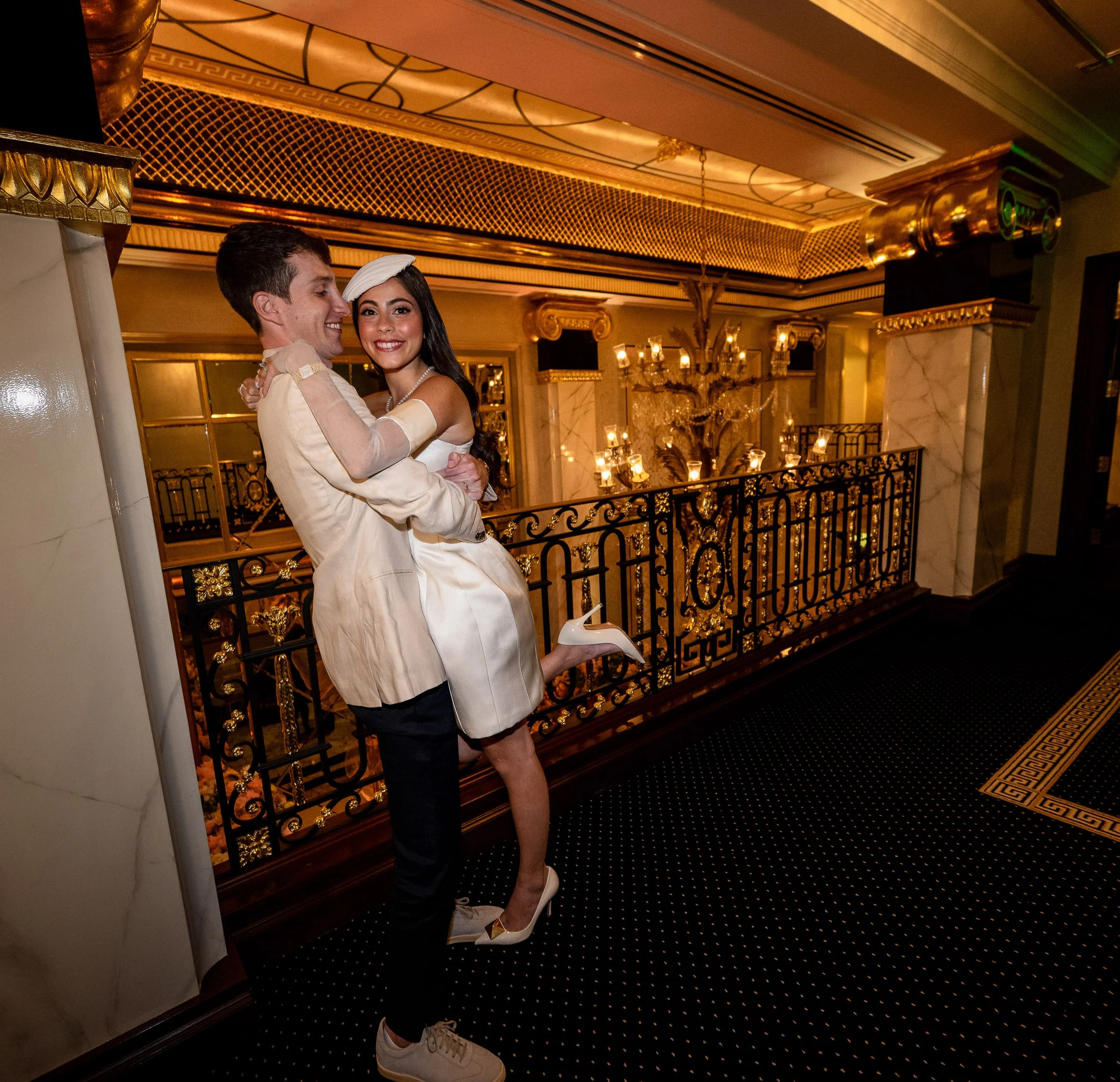 The groom lifting the bride in a short white dress on the balcony — Shadowbrook at Shrewsbury, Shrewsbury