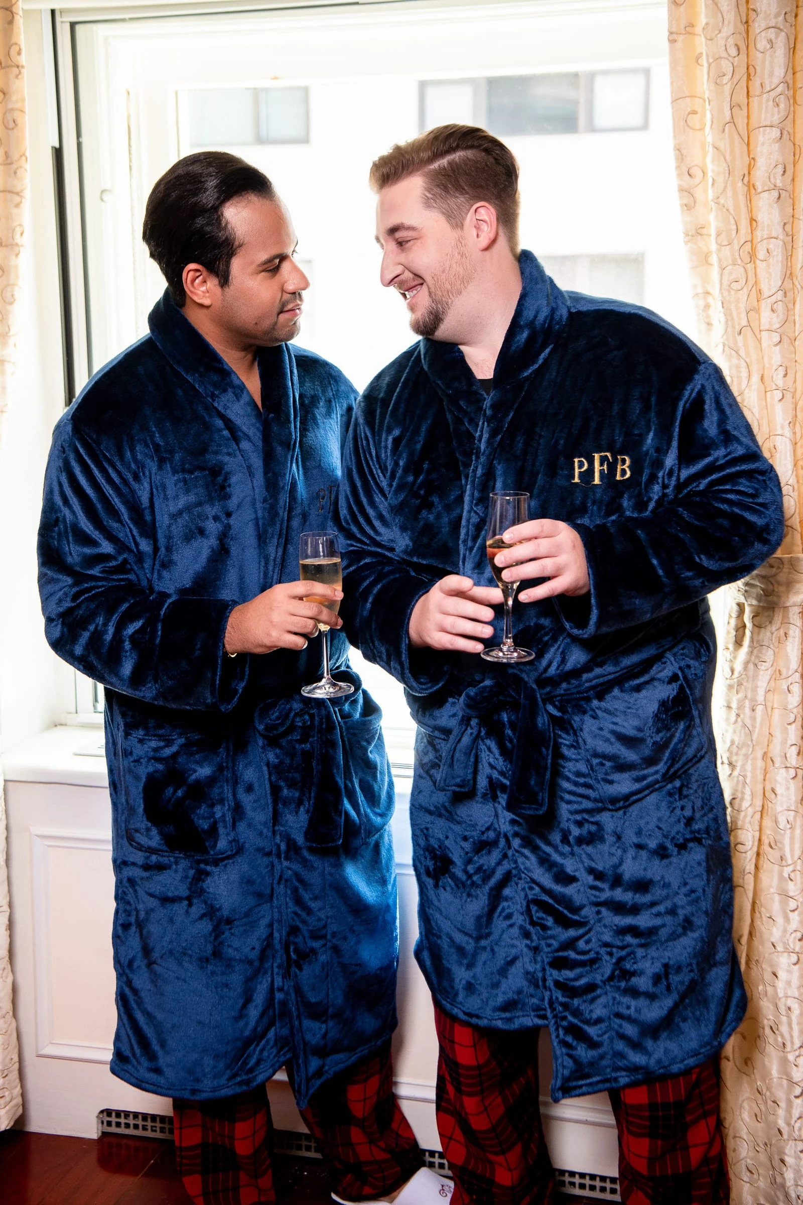 The grooms in monogrammed robes with champagne before dressing — Metropolitan Club, New York