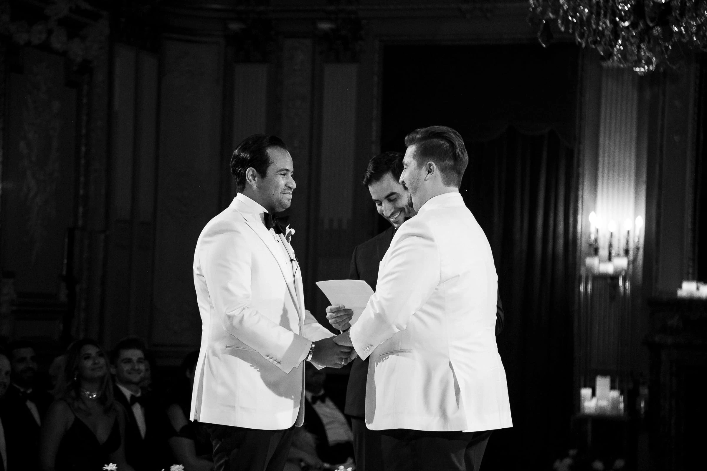 The grooms reading their vows to each other, in black and white — Metropolitan Club, New York