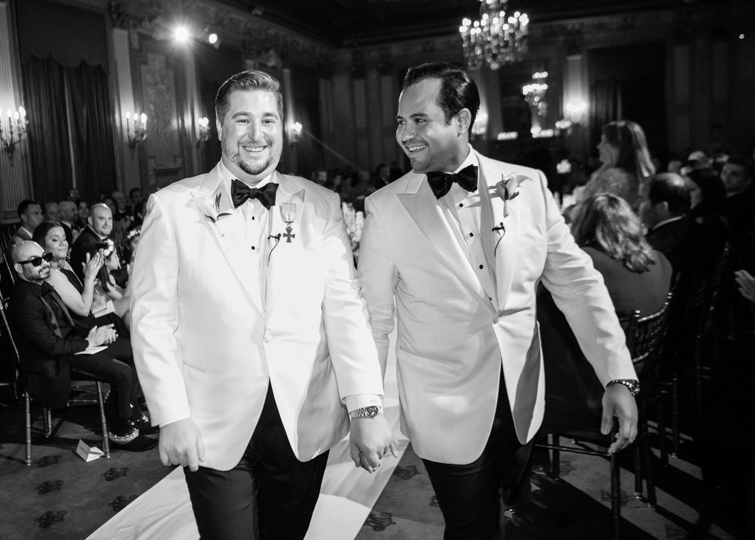 The grooms walking back down the aisle together — Metropolitan Club, New York