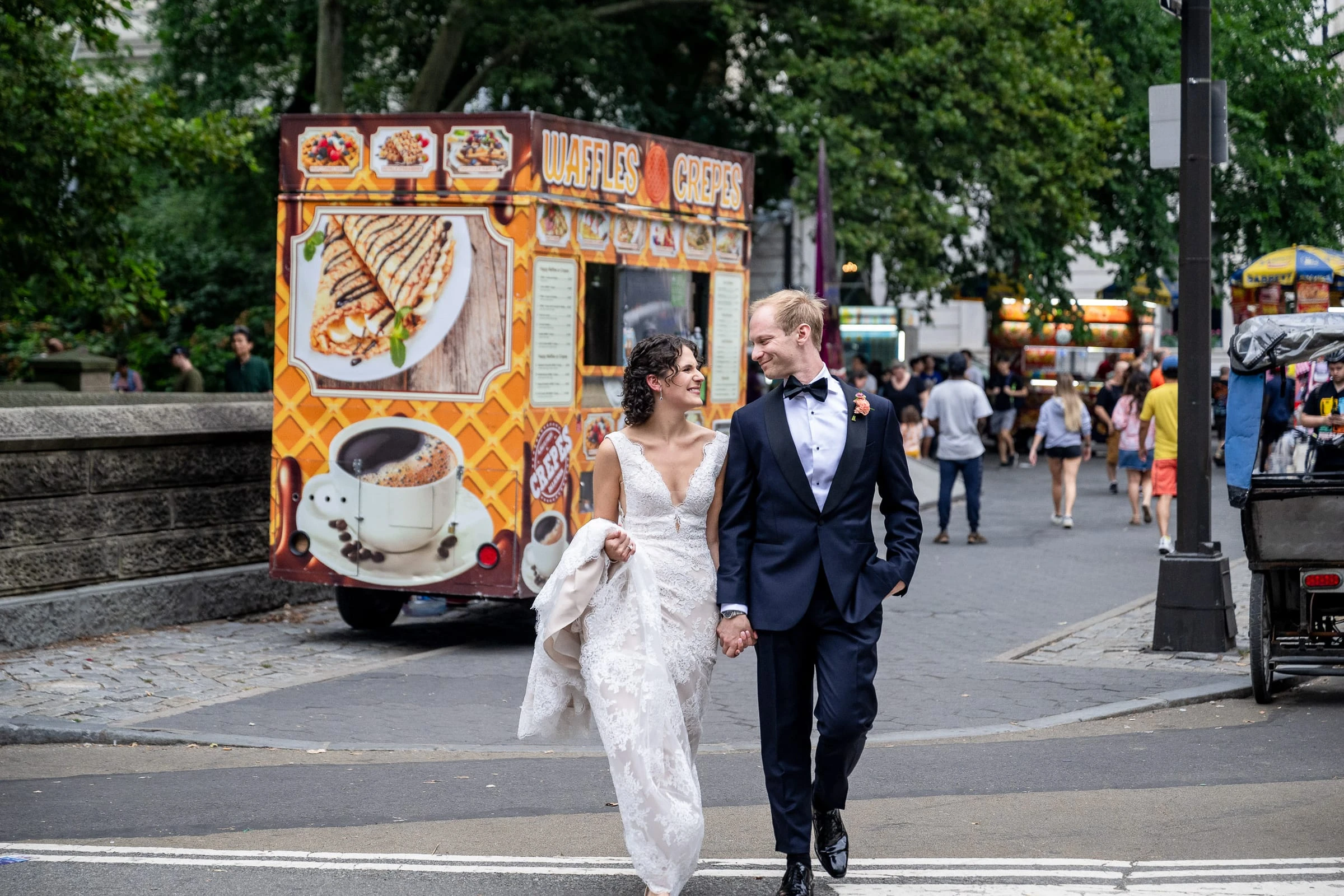 The couple walking past a street food cart on the way to the park — Metropolitan Club, New York