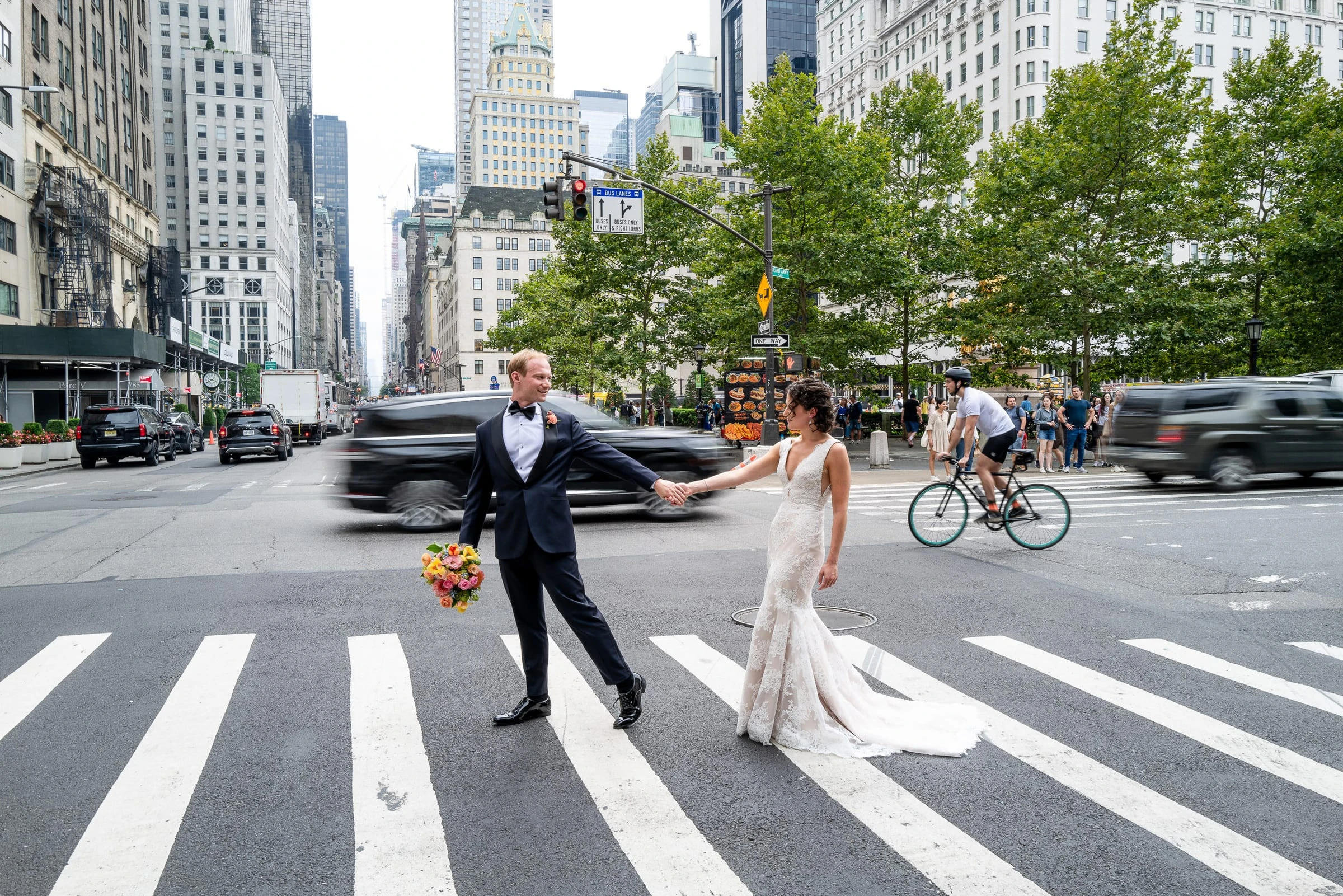The couple crossing the avenue in the crosswalk as traffic waits — Metropolitan Club, New York