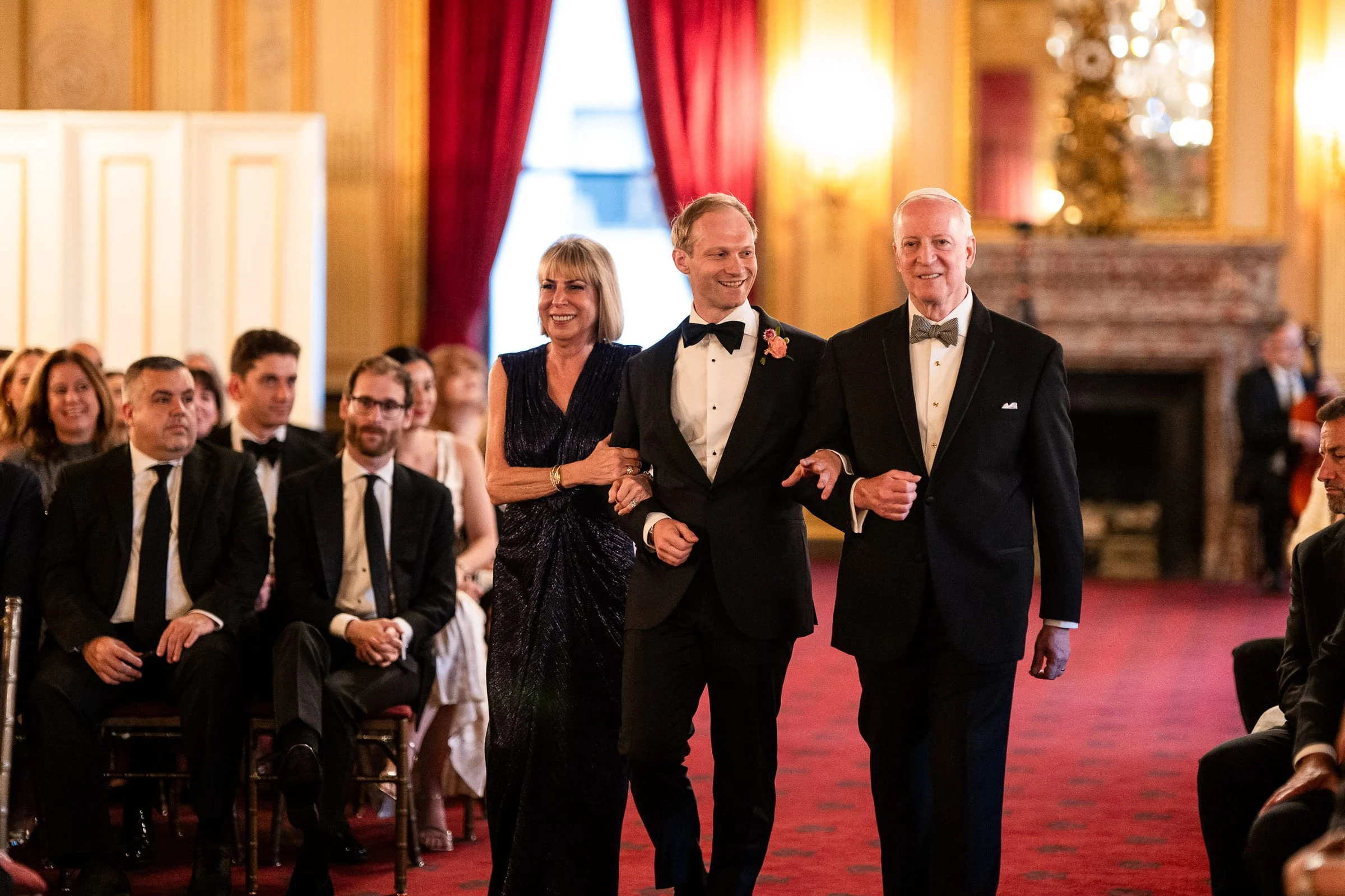 The groom walking the aisle between his parents — Metropolitan Club, New York