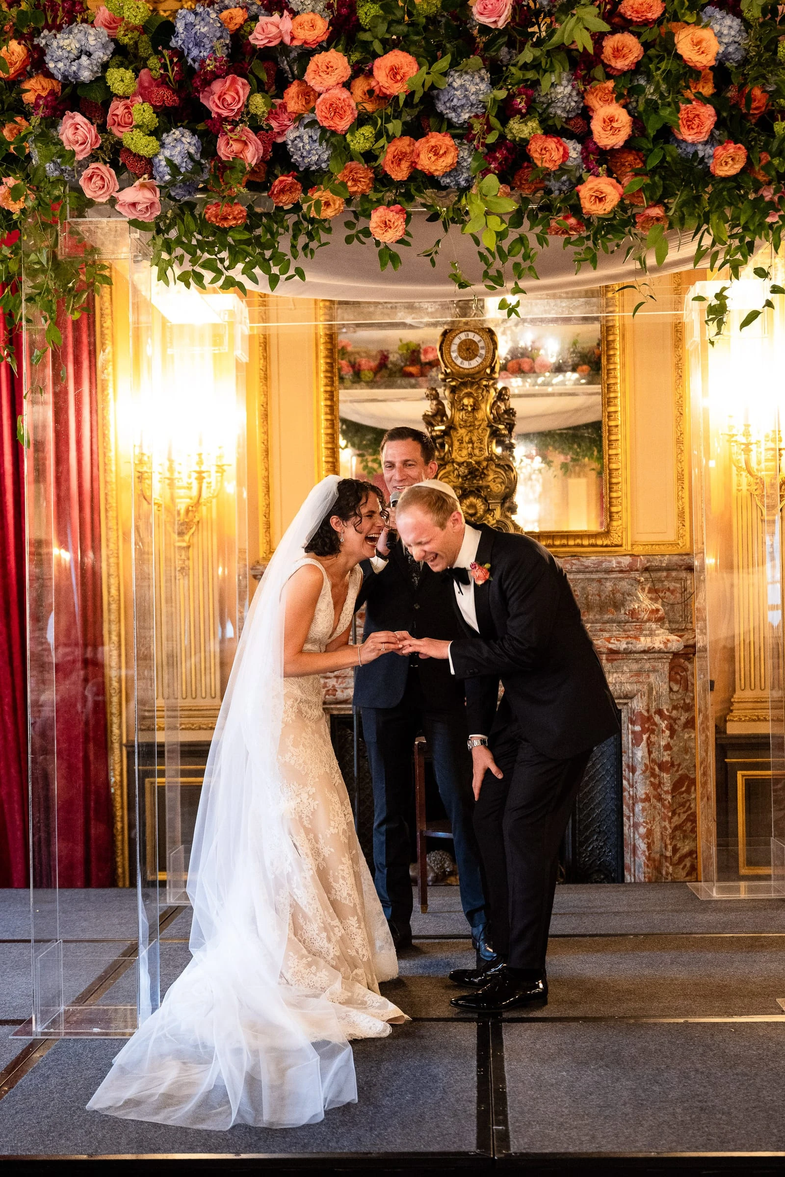 The couple beneath the chuppah as the glass is broken — Metropolitan Club, New York