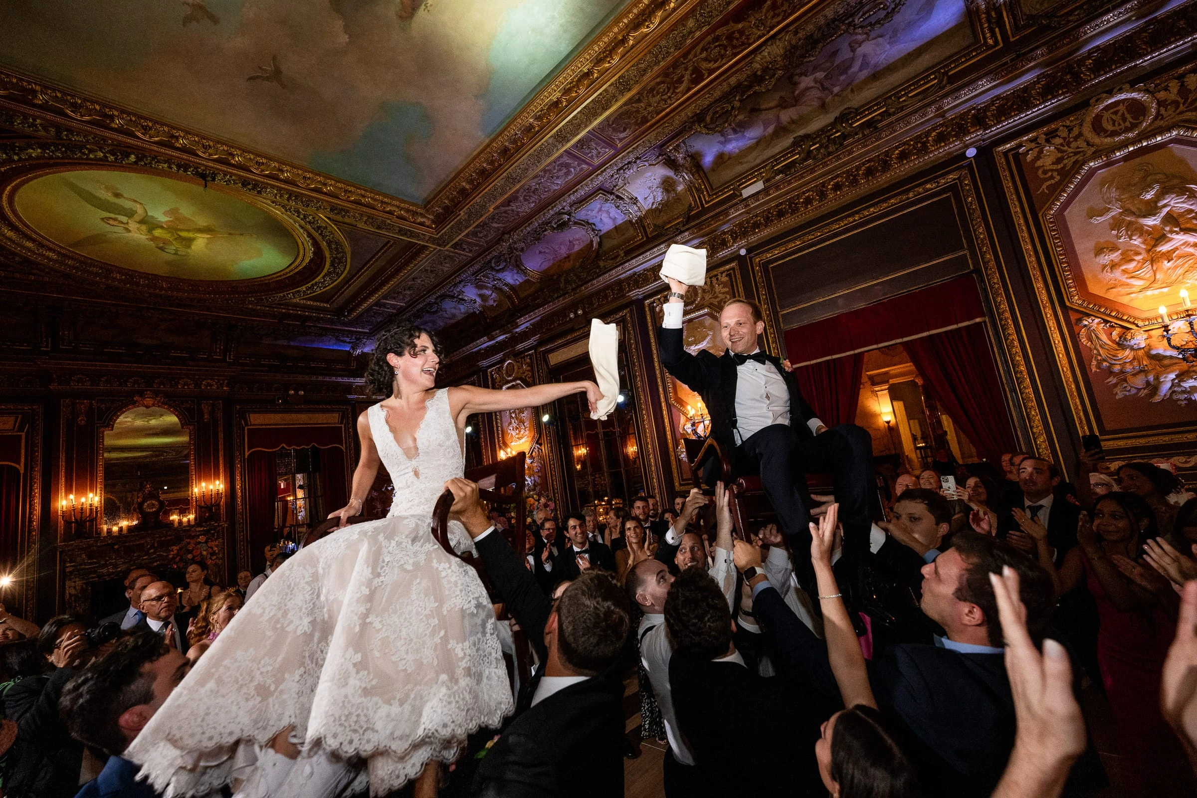 The bride lifted on a chair above the crowd during the hora — Metropolitan Club, New York