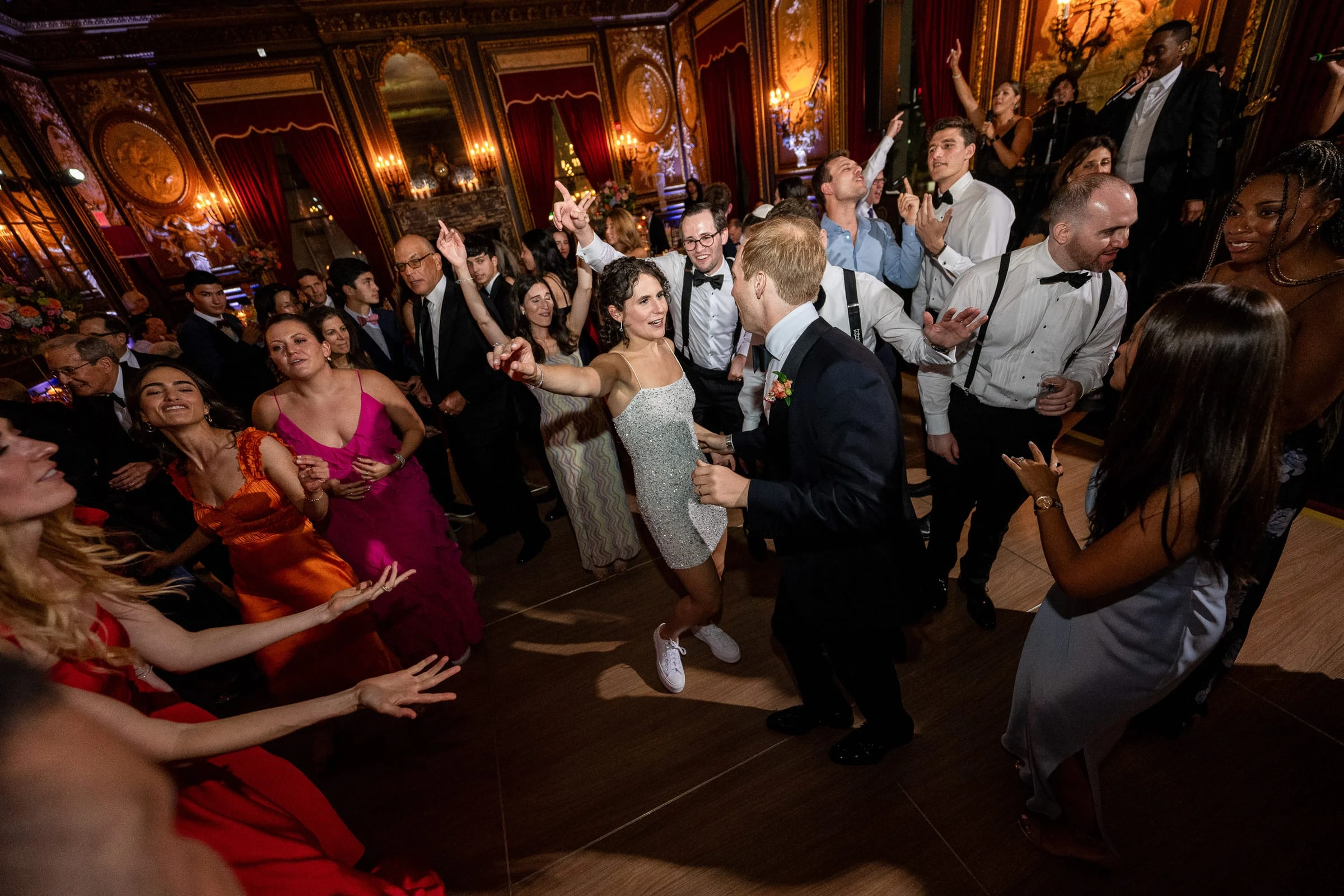 Guests dancing close around the bride and groom late in the night — Metropolitan Club, New York