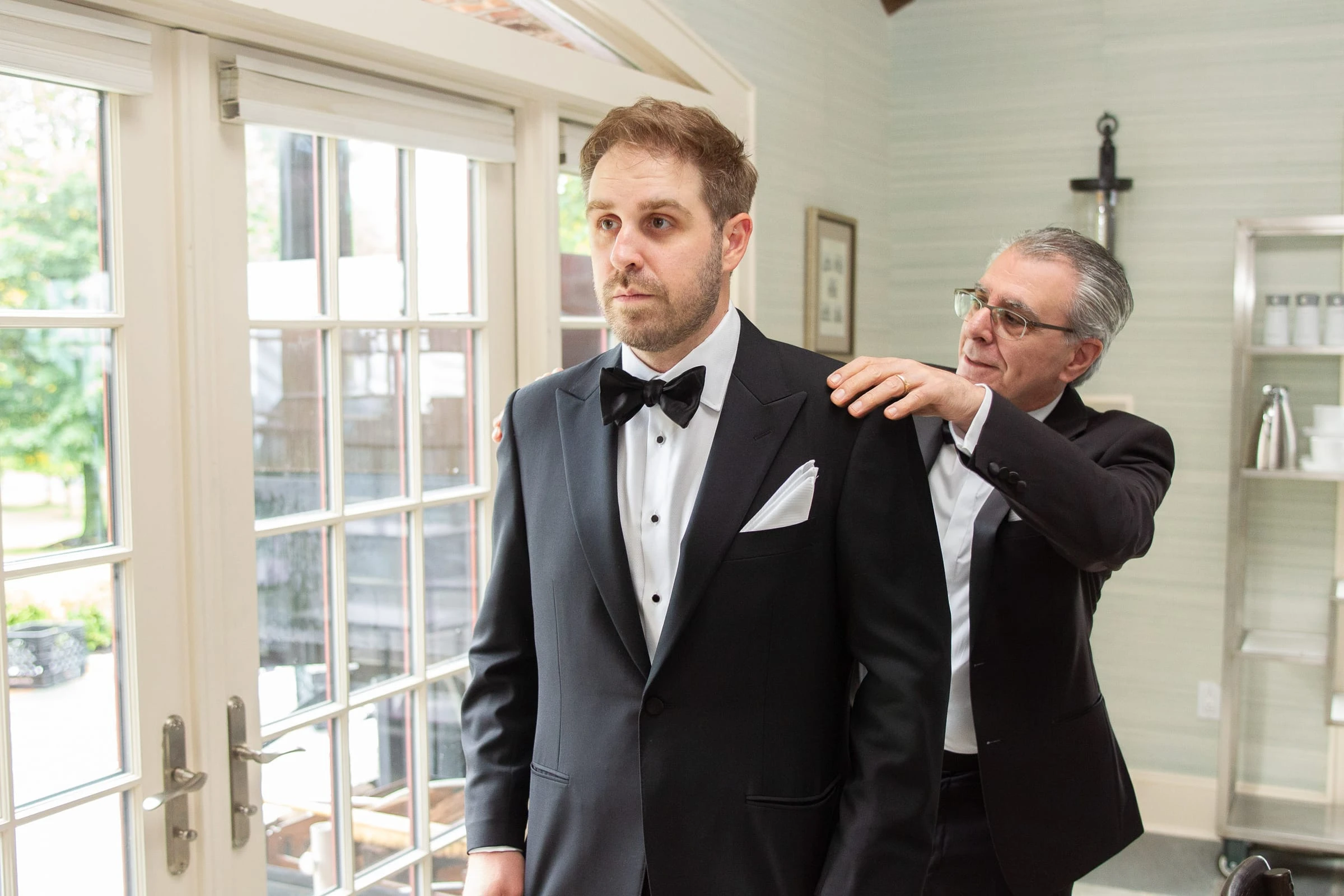 The groom having his jacket straightened before the ceremony — Mountain Ridge Country Club, West Caldwell