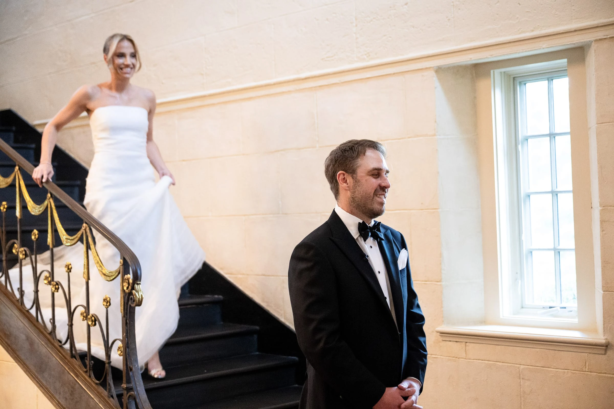 The bride coming down the stone staircase behind the waiting groom — Mountain Ridge Country Club, West Caldwell