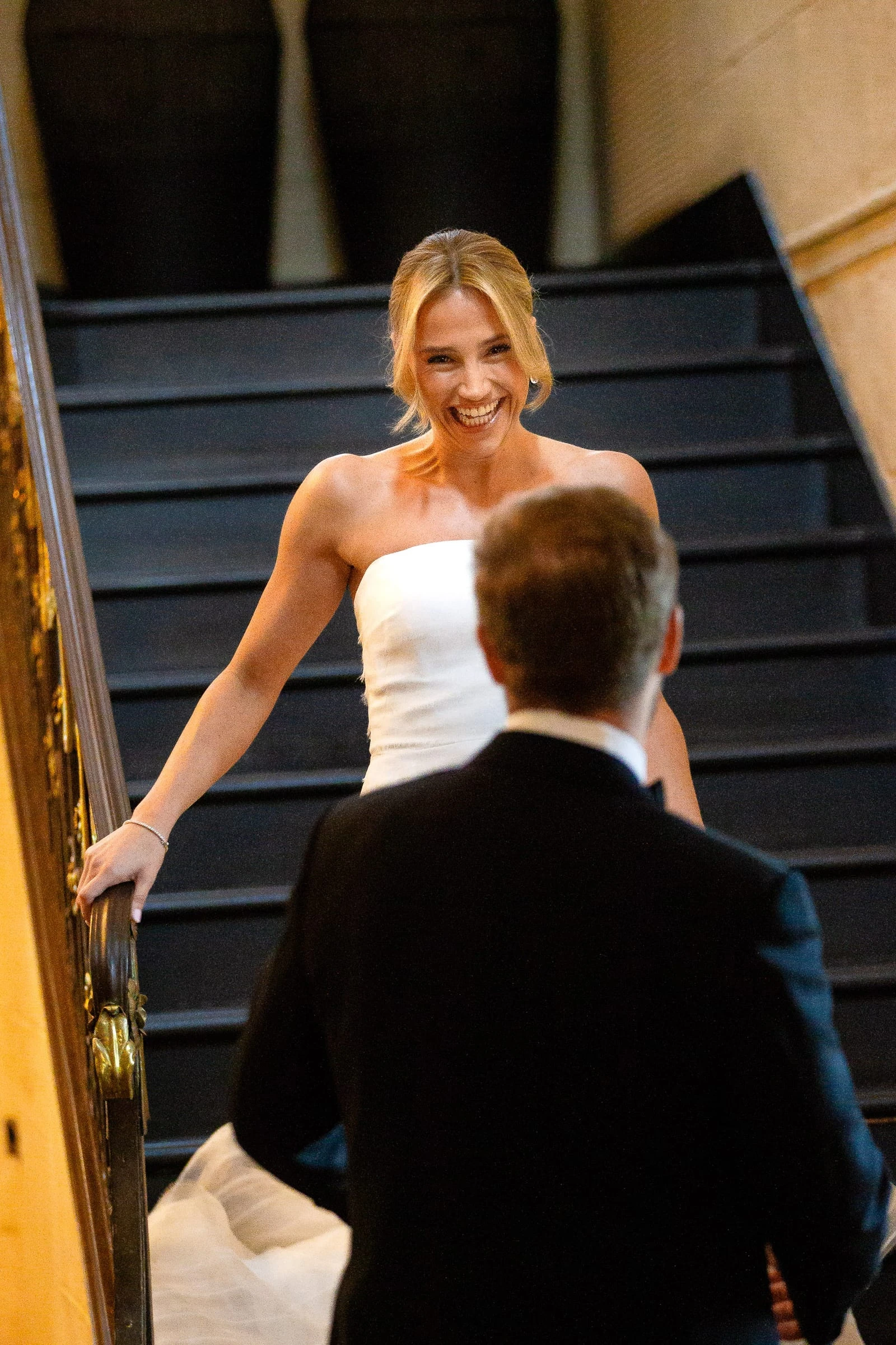The bride reaching the groom at the foot of the stairs — Mountain Ridge Country Club, West Caldwell