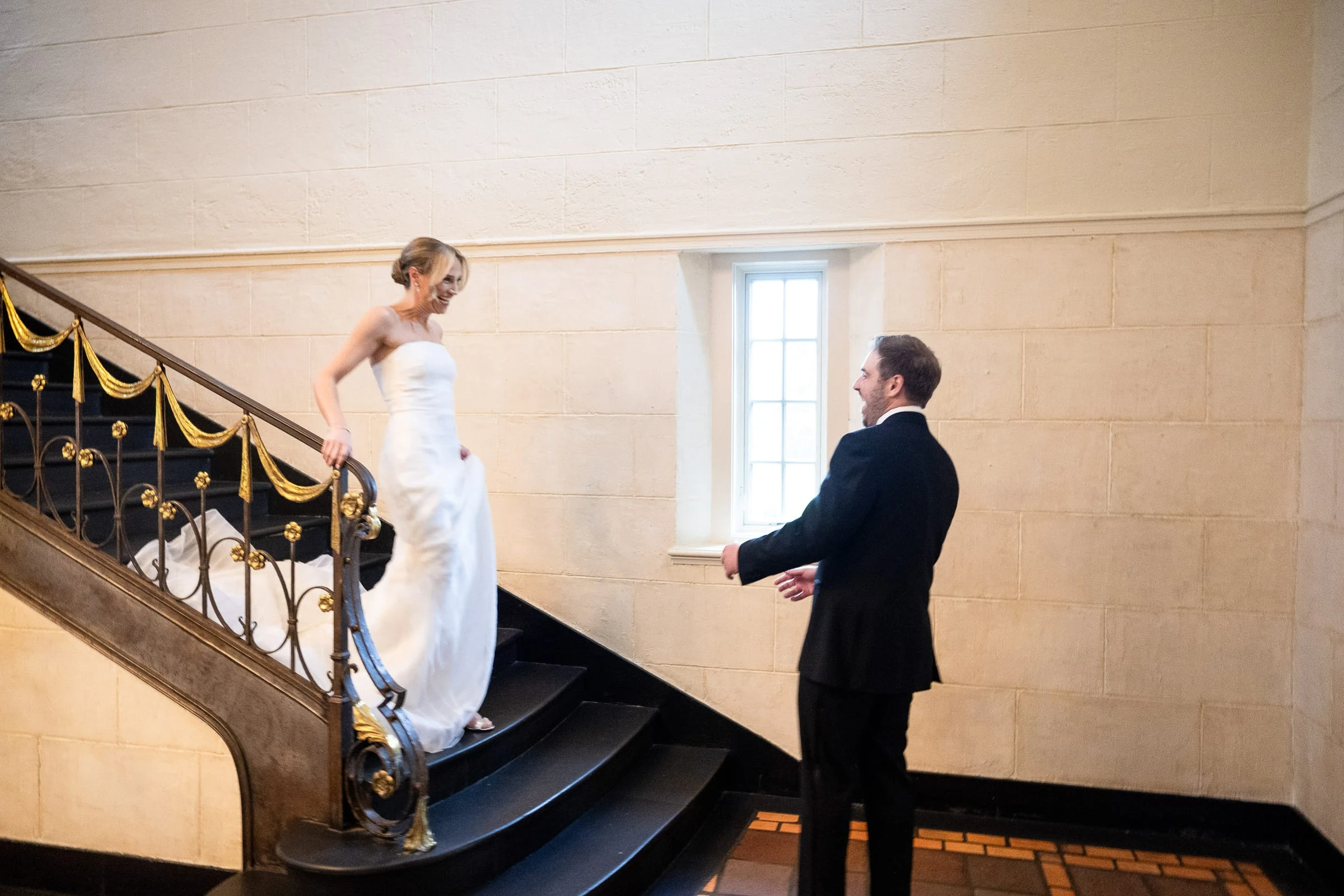 The groom waiting with his back turned as the bride comes down the stairs — Mountain Ridge Country Club, West Caldwell