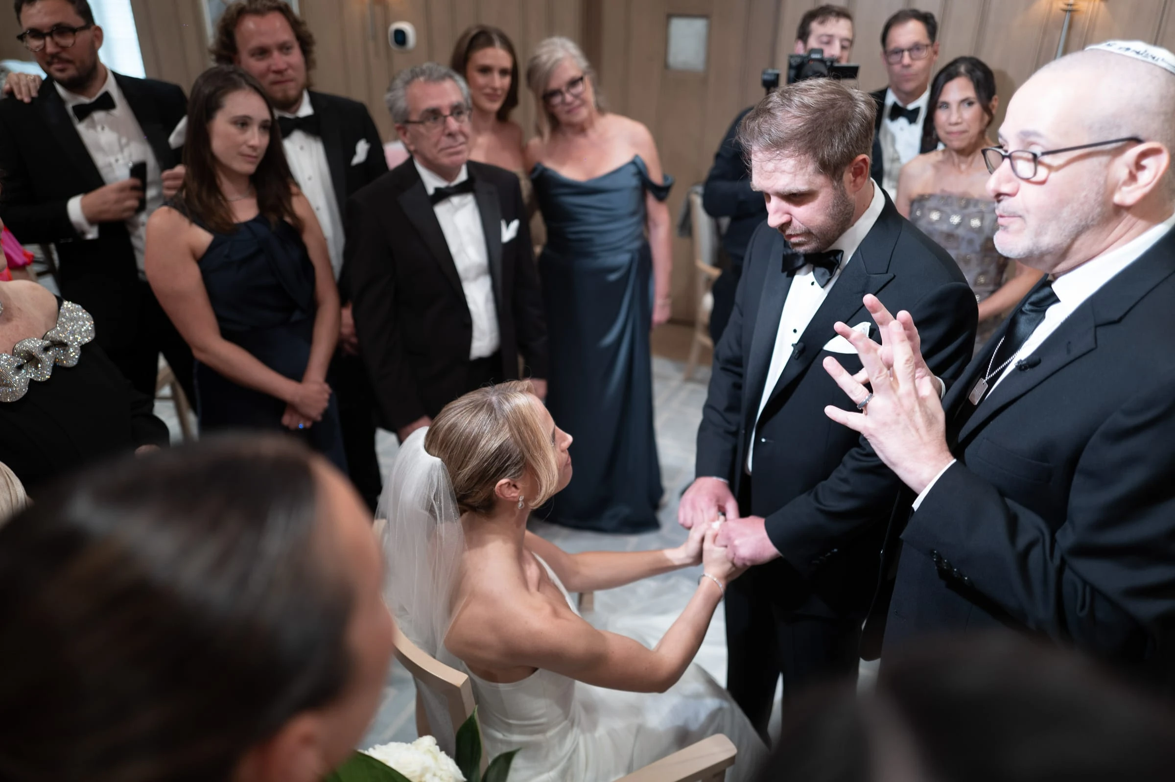 The couple holding hands before the rabbi as the family look on — Mountain Ridge Country Club, West Caldwell