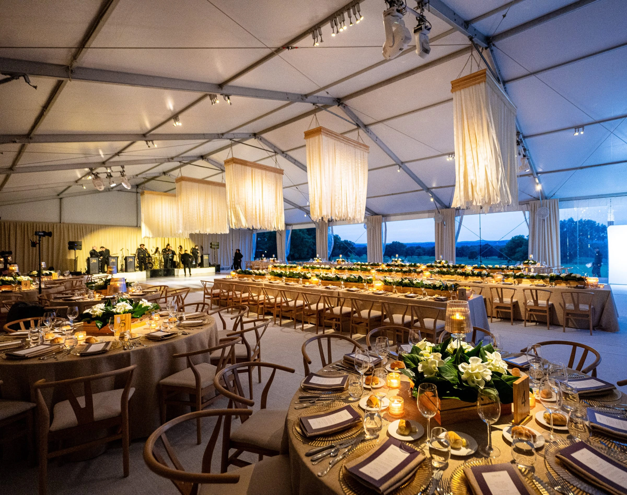 The reception tent set with long candlelit tables, white flowers and hanging lanterns — Mountain Ridge Country Club, West Caldwell