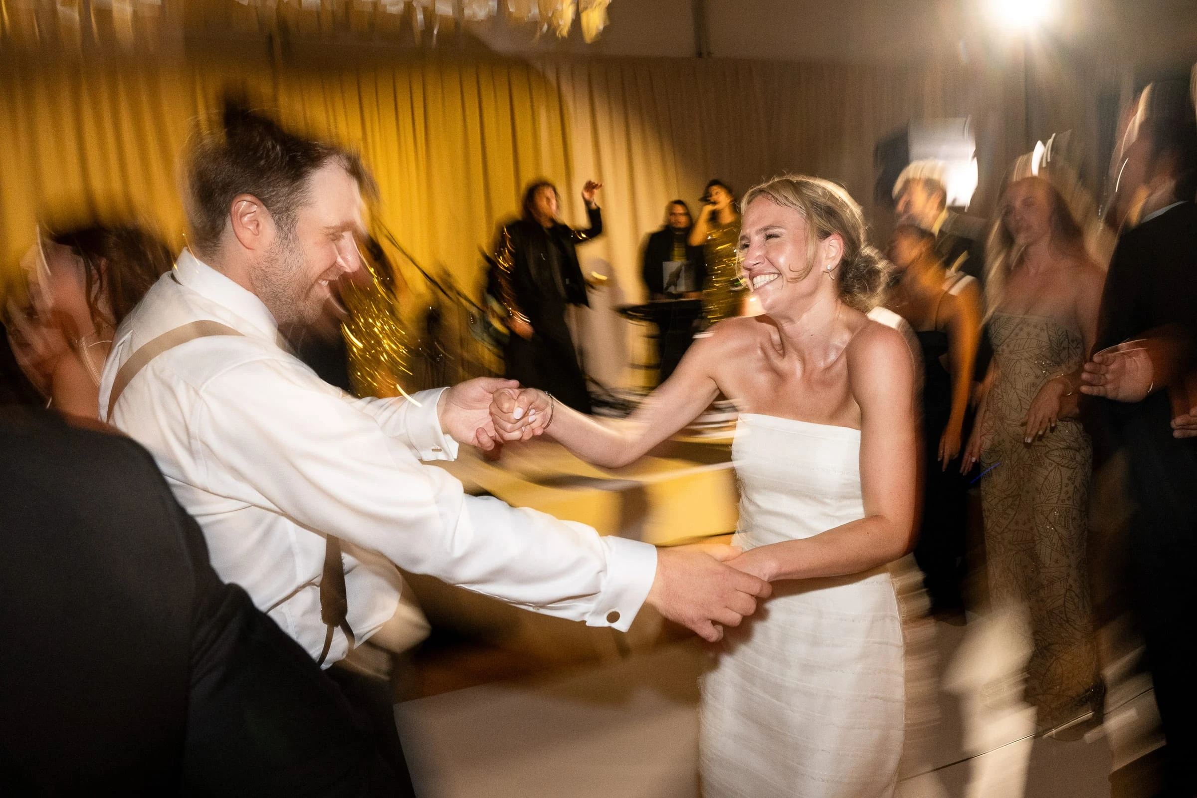 The bride and a guest spinning hand in hand on the dance floor — Mountain Ridge Country Club, West Caldwell