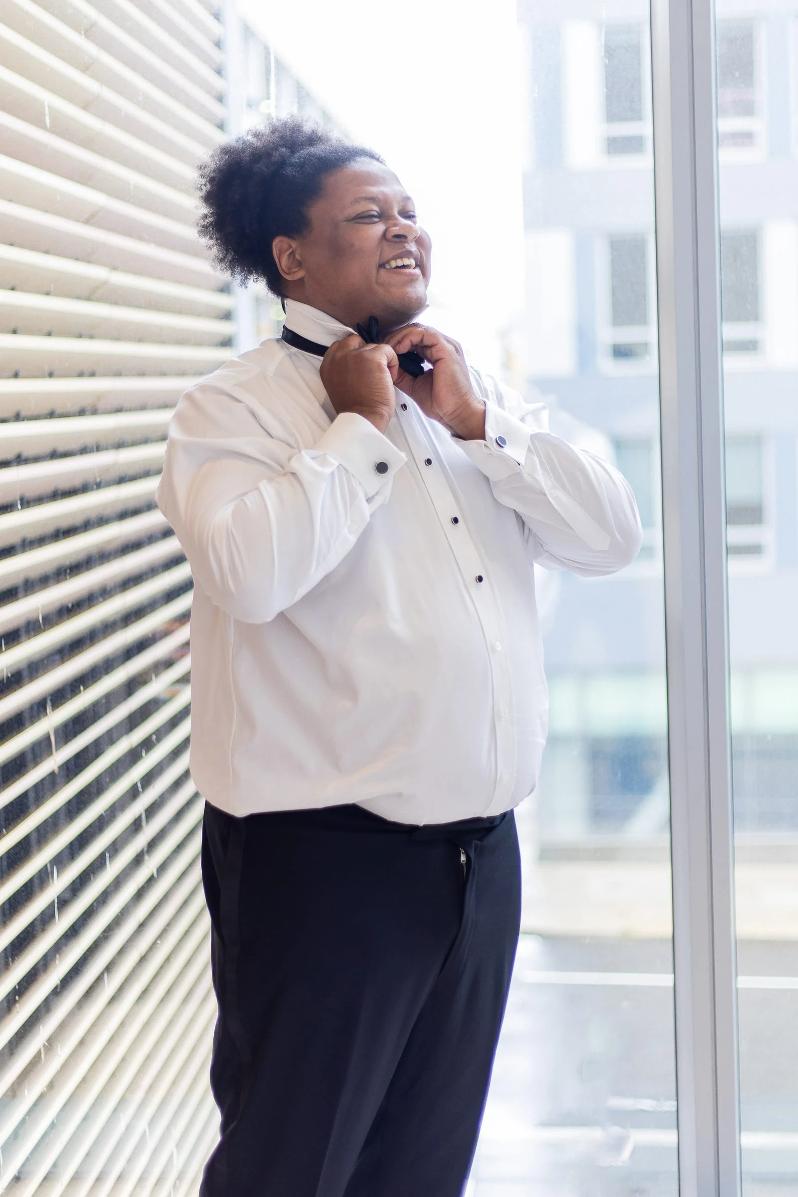 Fastening a bow tie at the window before the ceremony — Philadelphia Museum of Art, Philadelphia
