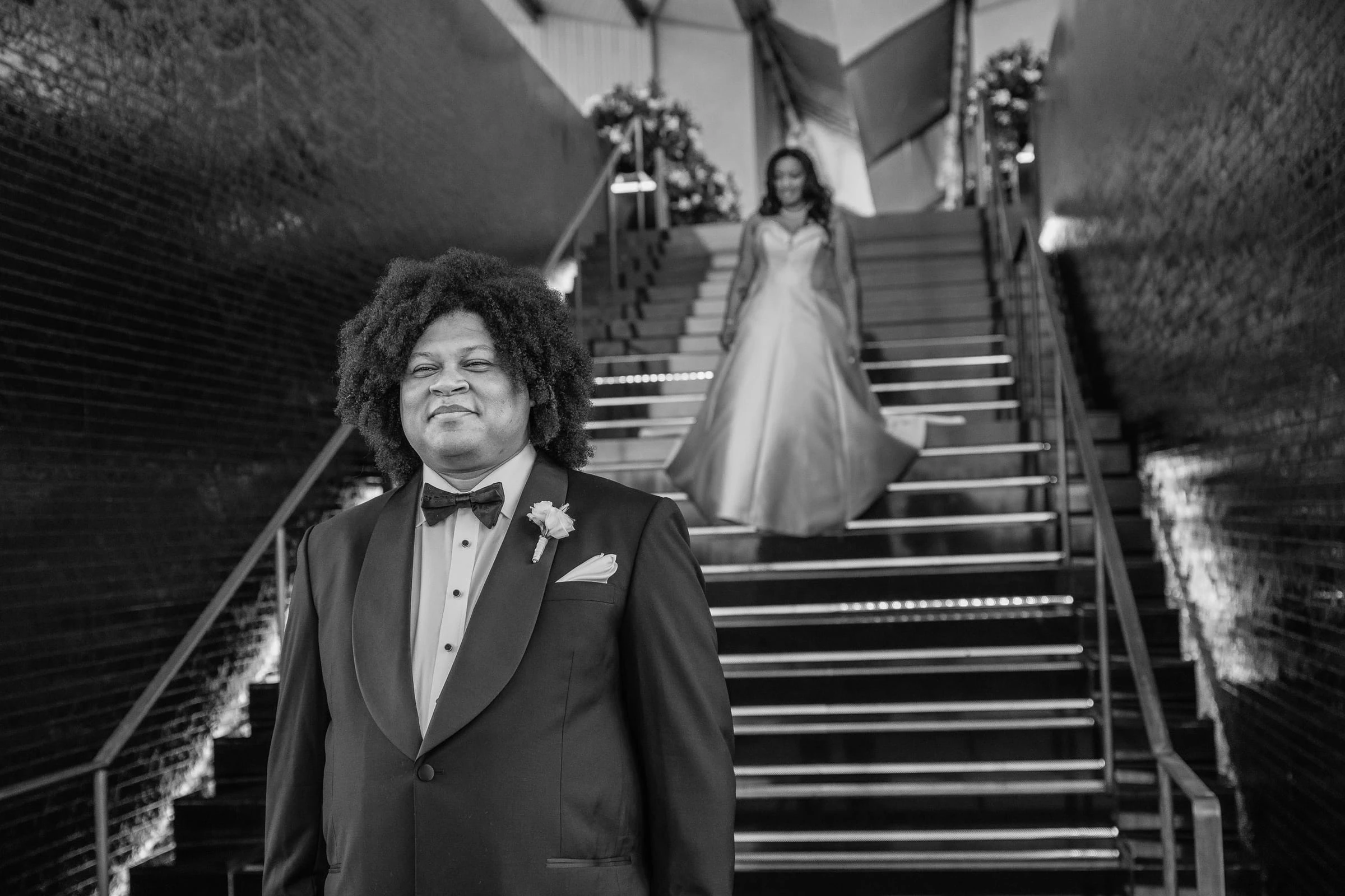 Waiting at the foot of the stairs as the bride comes down, in black and white — Philadelphia Museum of Art, Philadelphia