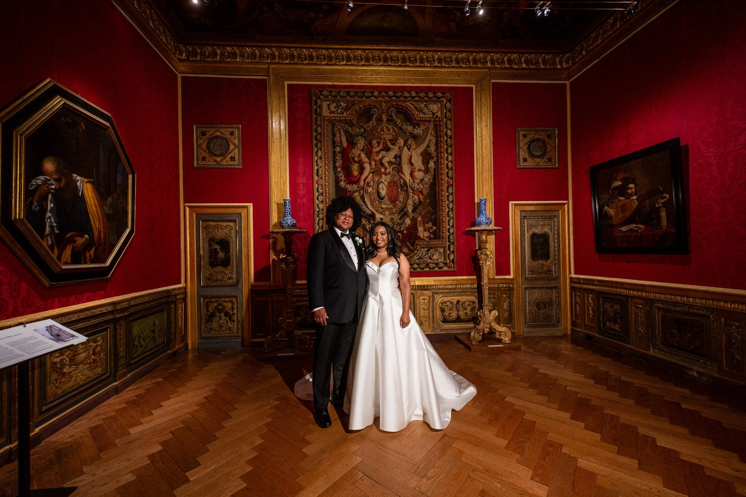 The couple in the red tapestry room among the gilded frames — Philadelphia Museum of Art, Philadelphia