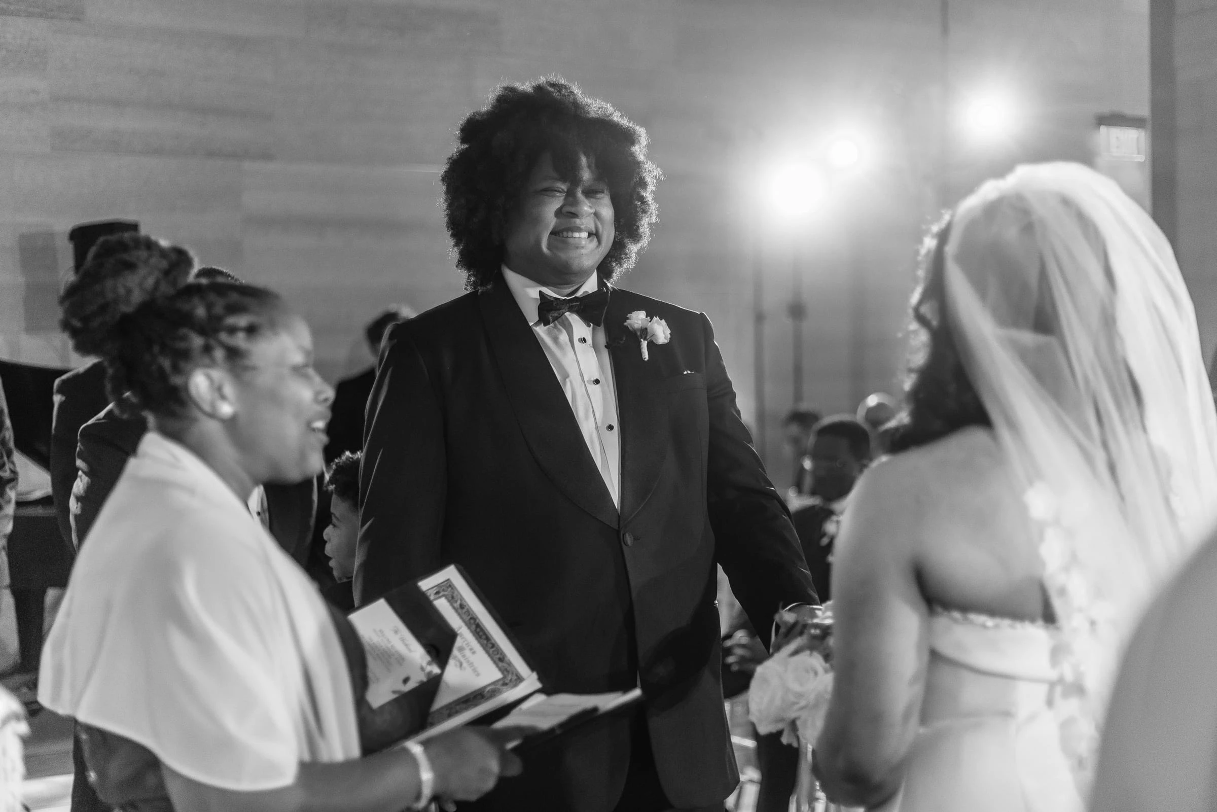 The officiant reading as the couple face each other, in black and white — Philadelphia Museum of Art, Philadelphia