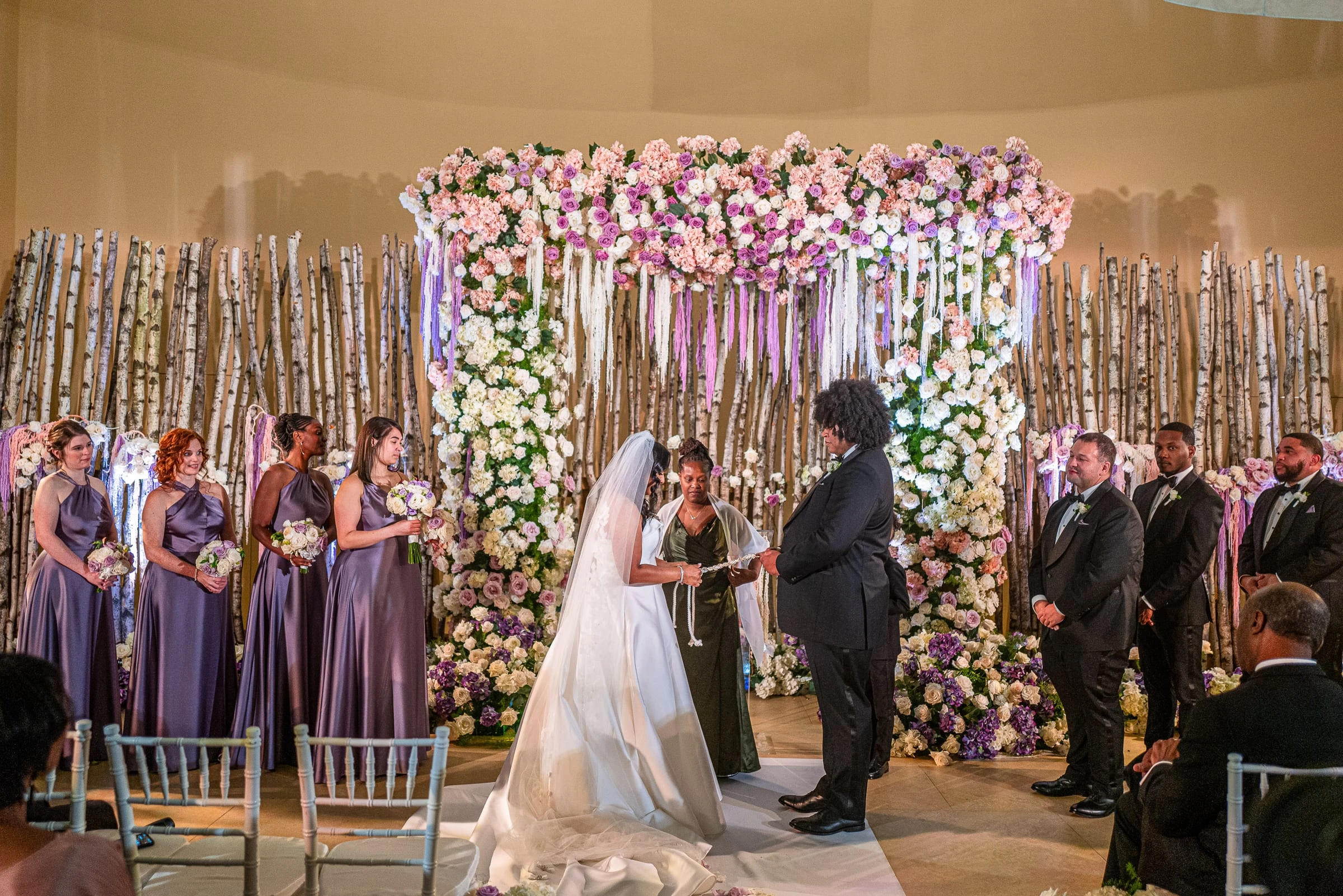 The couple at the flowered chuppah with the bridesmaids in lilac — Philadelphia Museum of Art, Philadelphia
