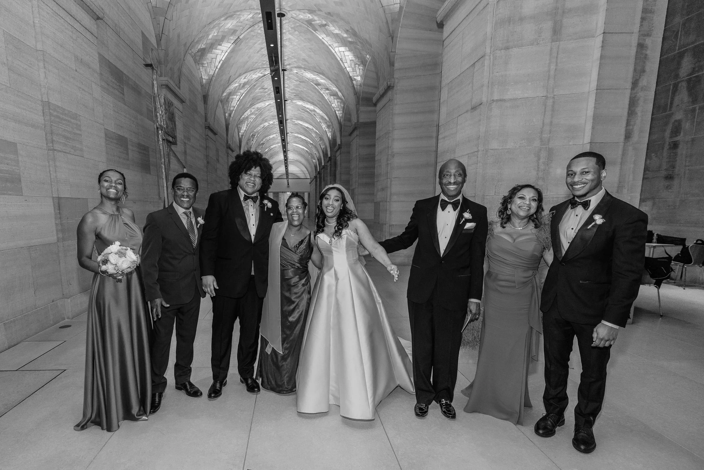 The families together in the vaulted stone corridor, in black and white — Philadelphia Museum of Art, Philadelphia