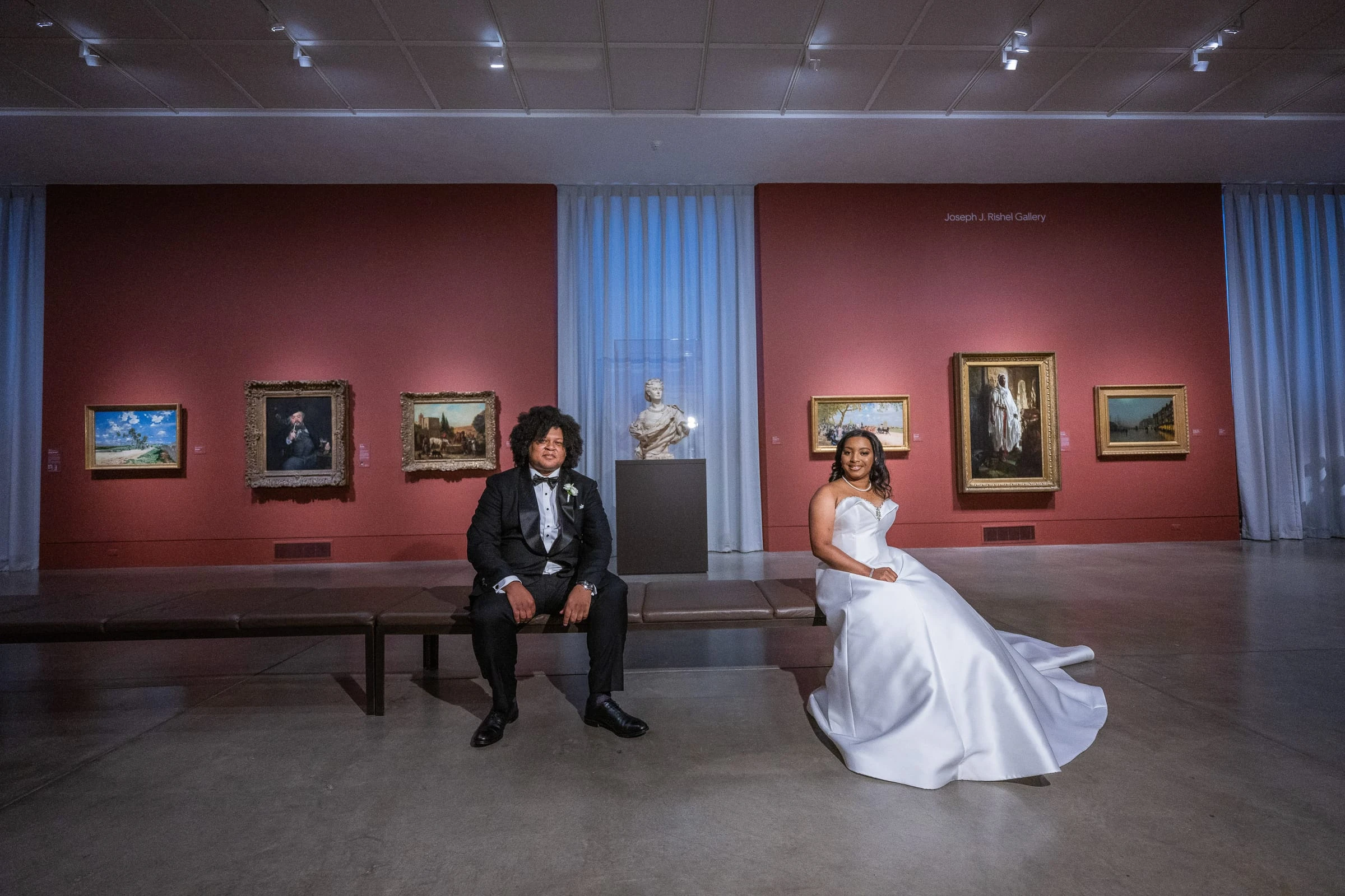 The couple in a red gallery hung with paintings — Philadelphia Museum of Art, Philadelphia