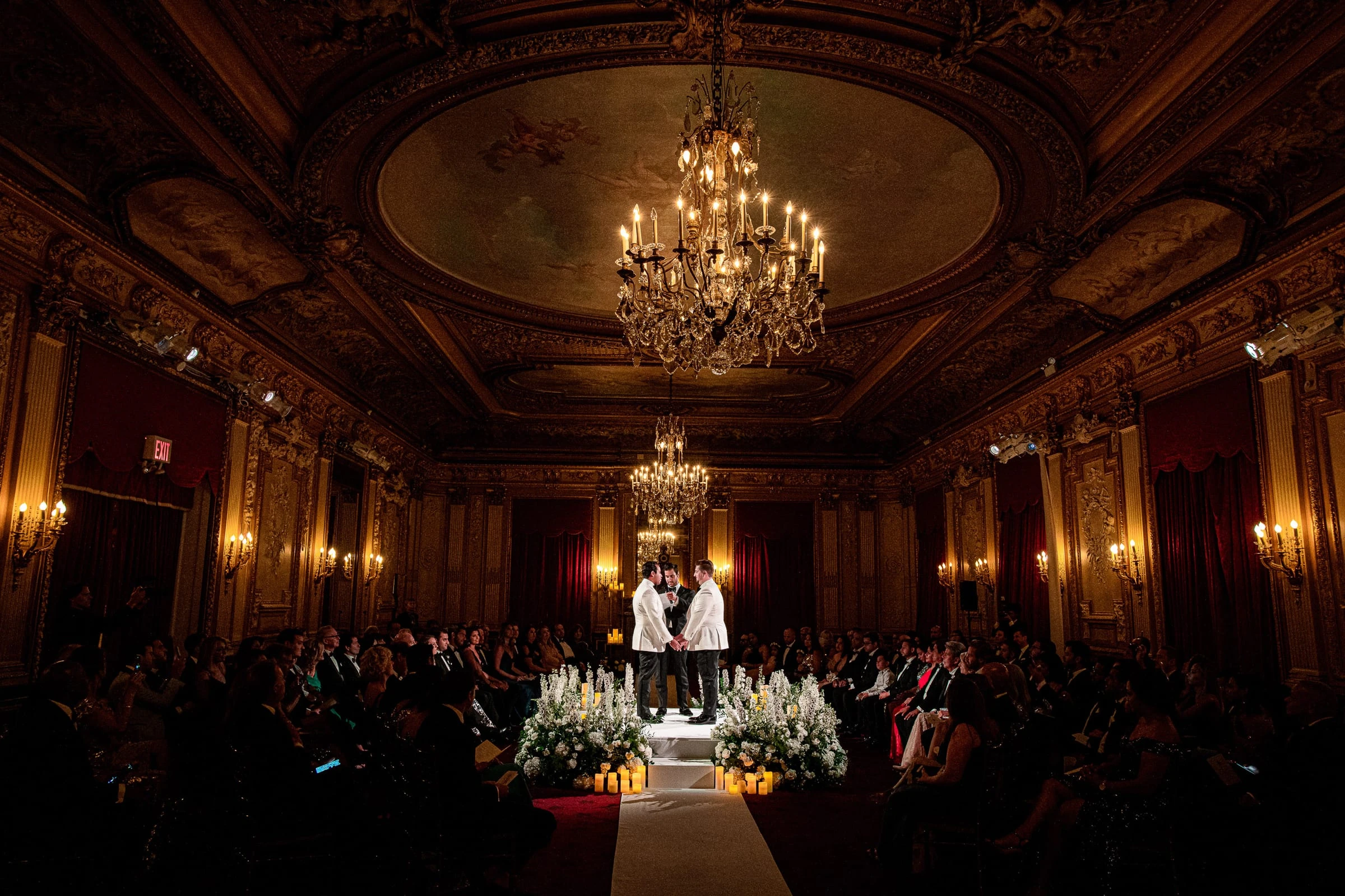 A ceremony beneath the painted dome and chandeliers of a gilded ballroom