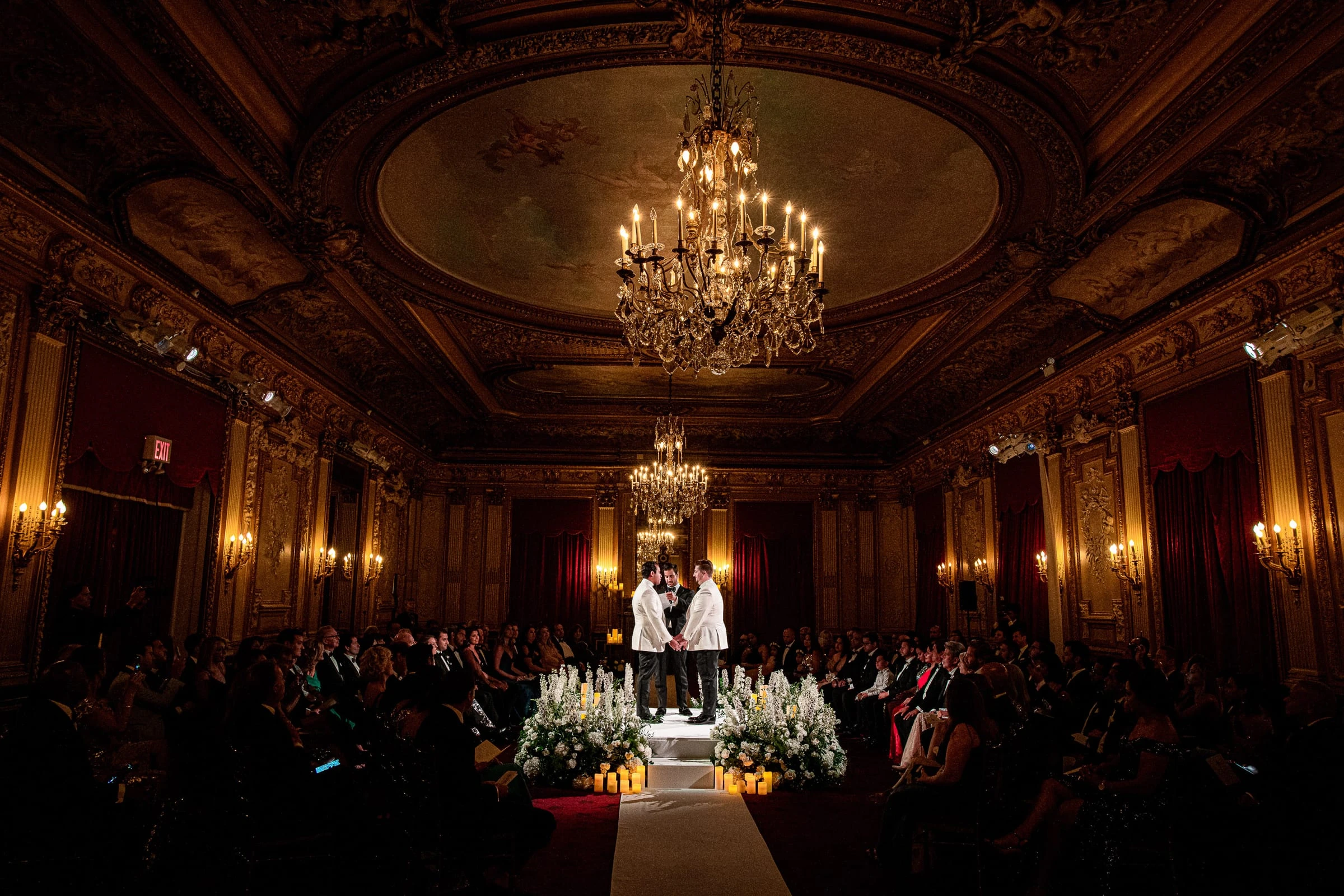 A ceremony beneath the painted dome and chandeliers of a gilded ballroom